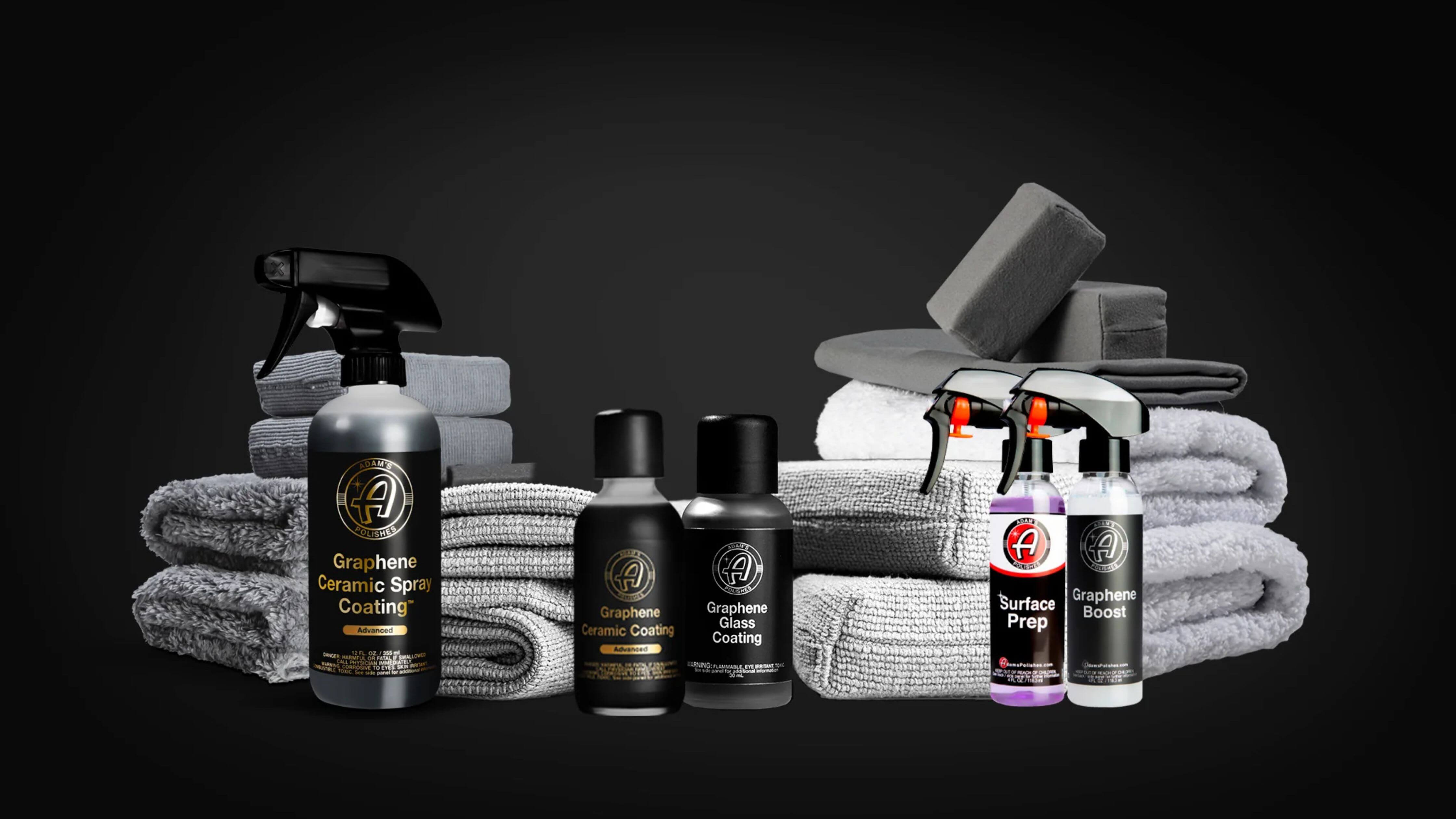 Car care products including Adam's Polishes soap, spray bottles, and applicator pads displayed on a dark background.
