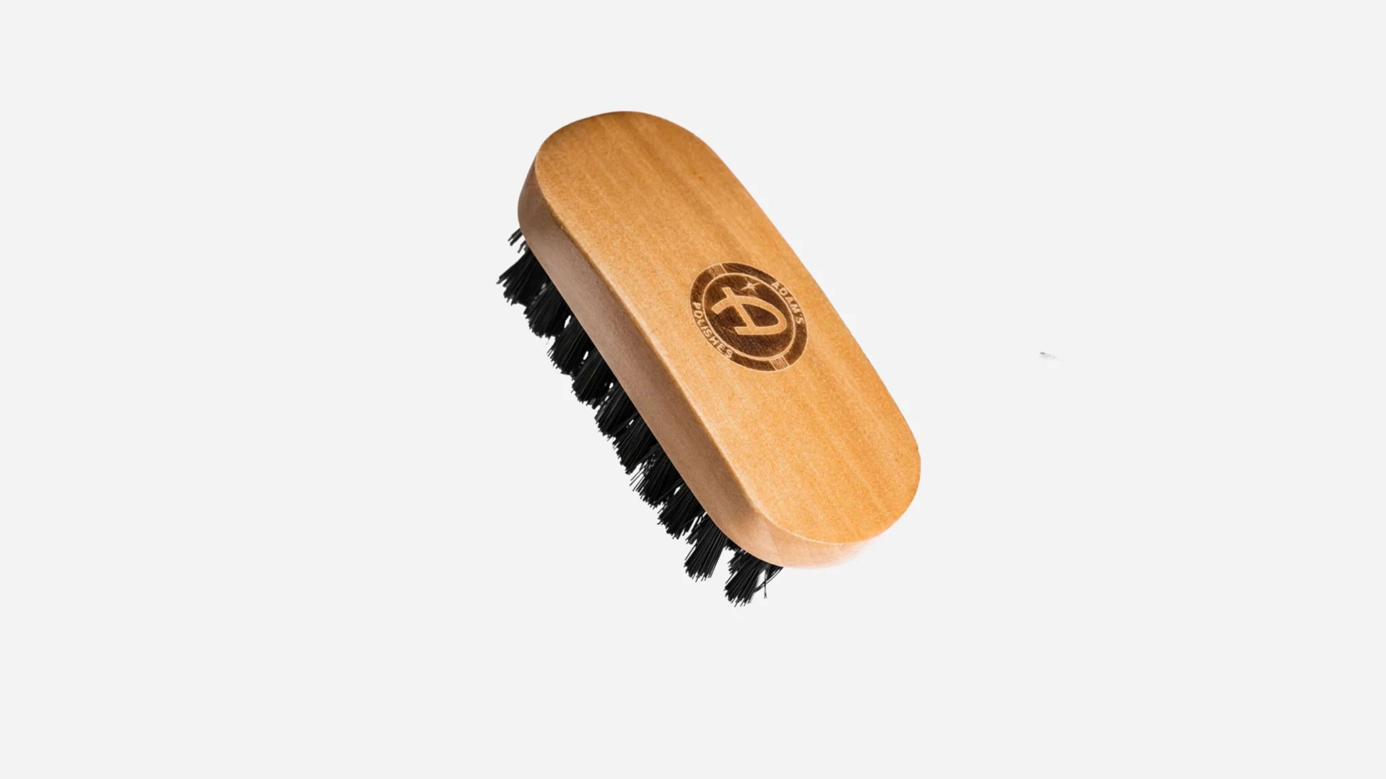 Bottle of Adam's Polishes car wash soap with wax on a wooden surface.
