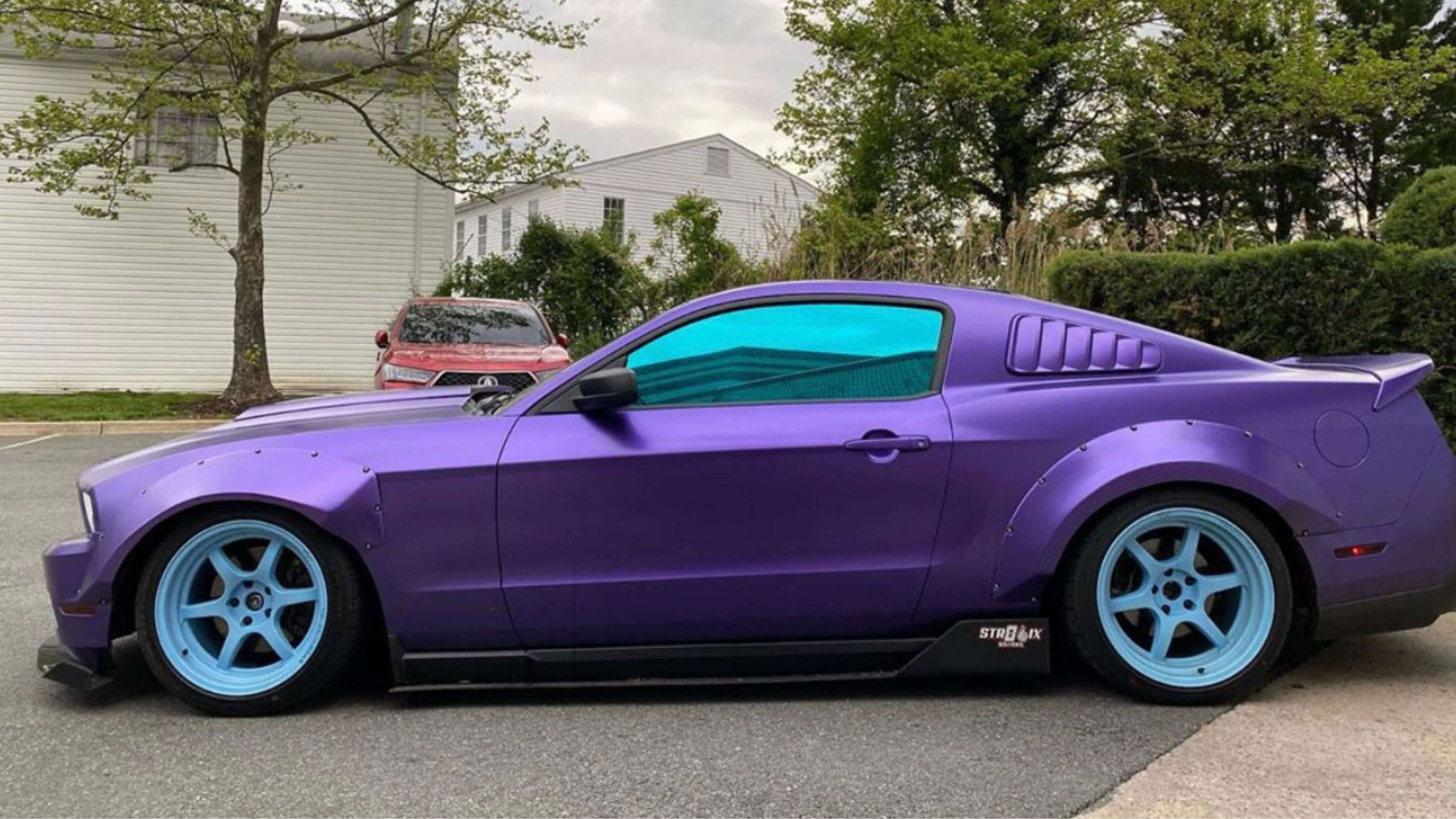 Purple sports car with tinted windows parked on a street, ideal for tint removal tutorial.