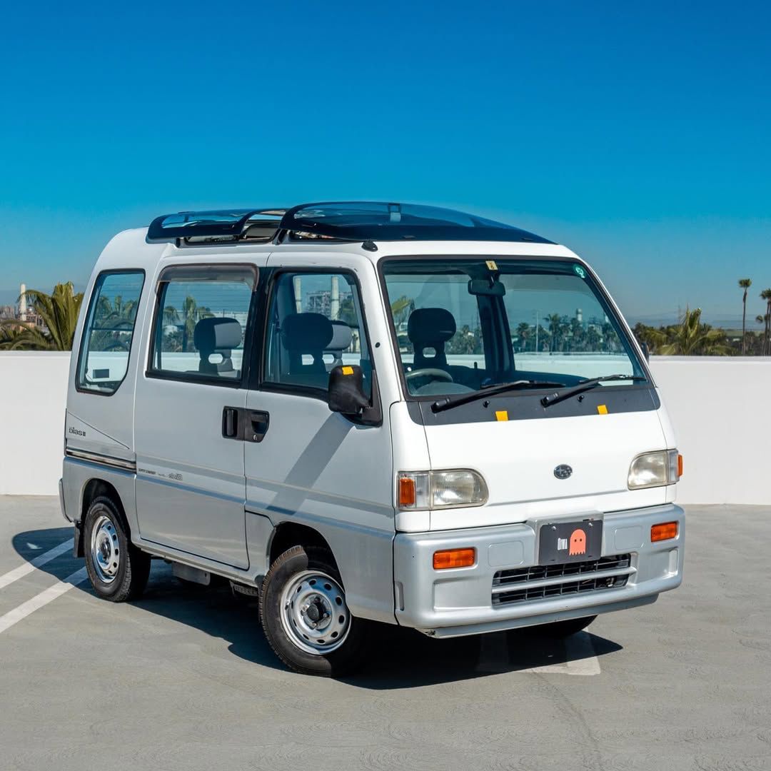 White Subaru Sambar kei van front quarter view with Oiwa Garage license plate