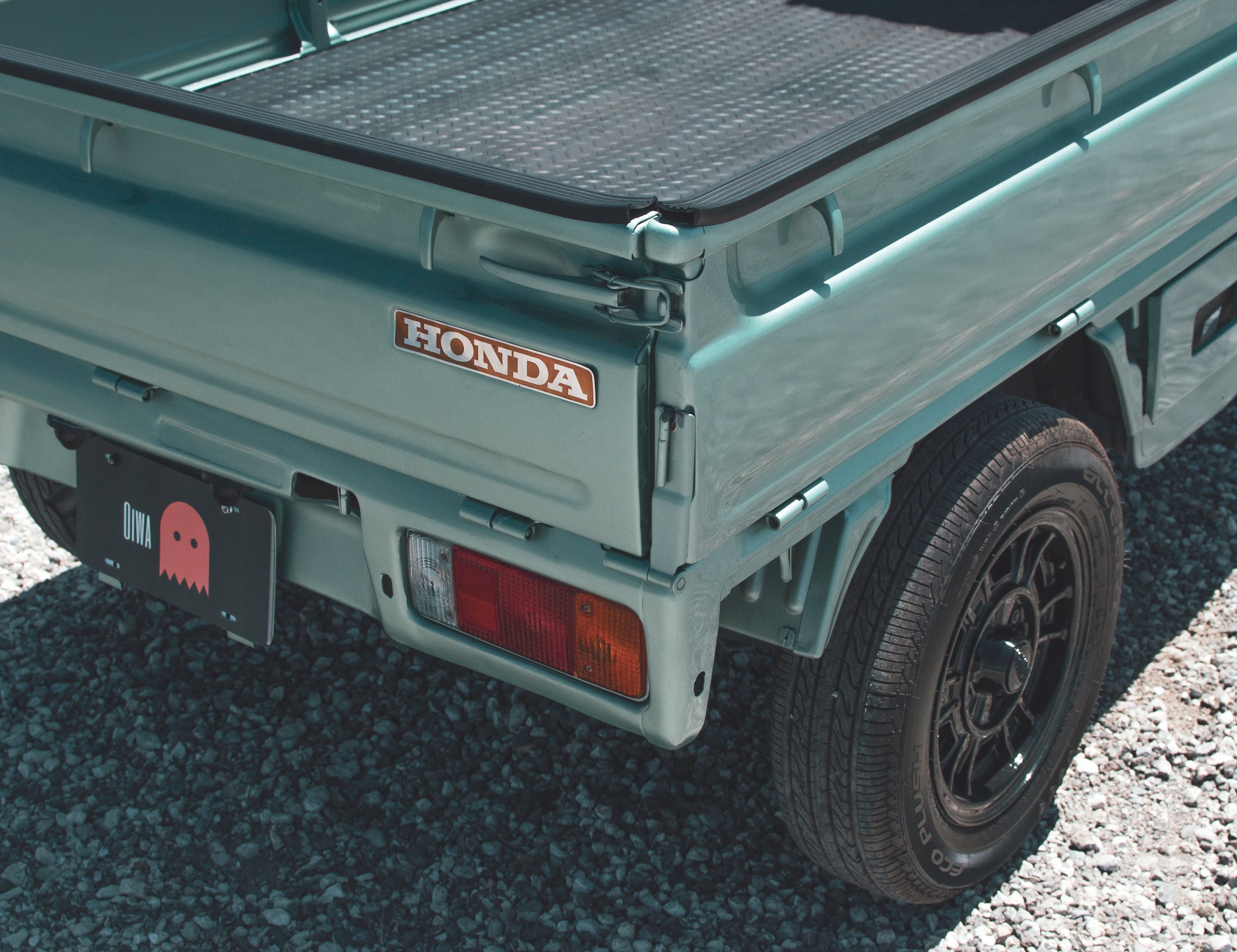 1995 Daihatsu Hijet kei truck in urban setting, showcasing compact design and efficiency.