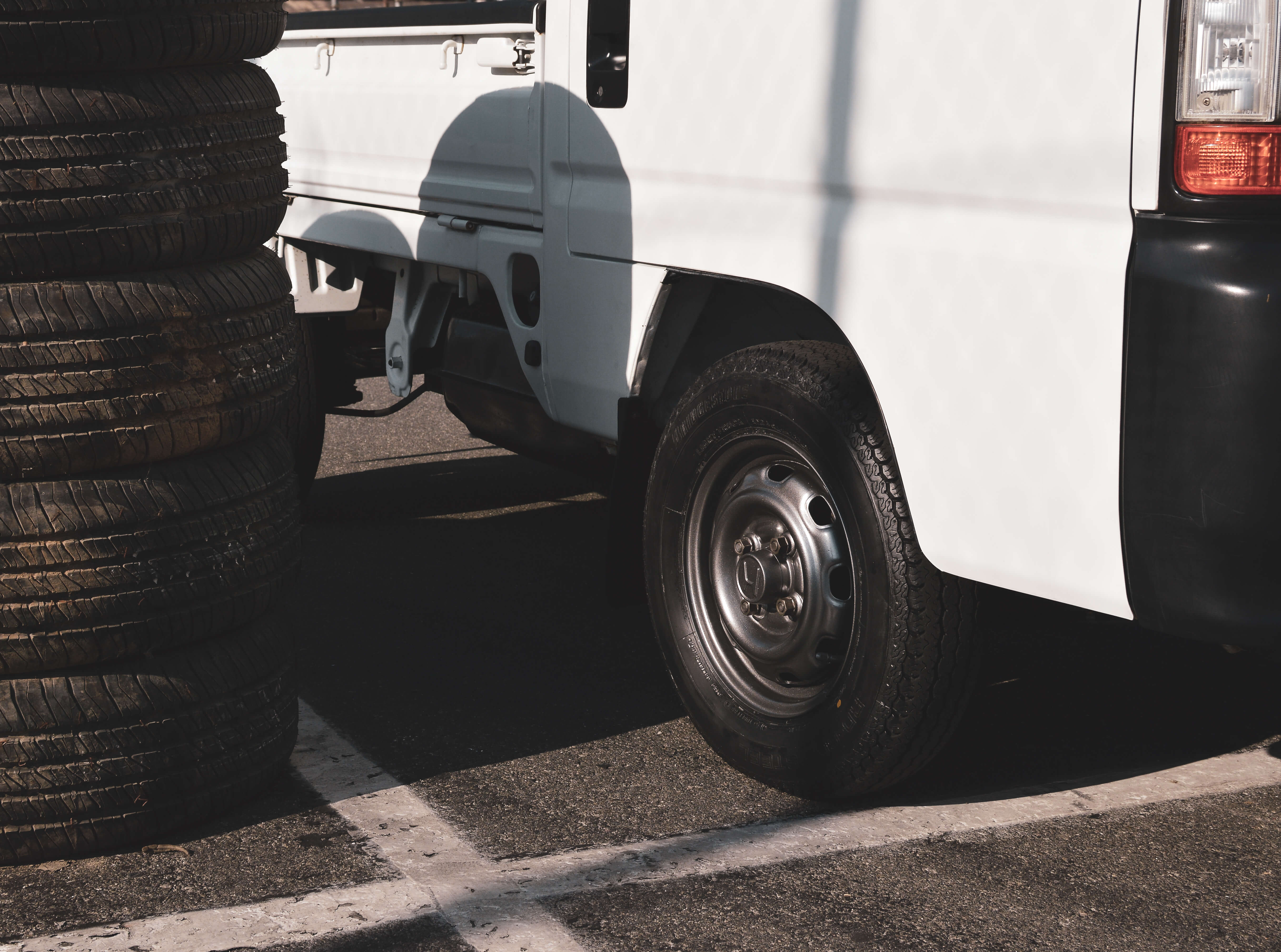 2024 Daihatsu Hijet Microvan with a minimalist design parked in an urban setting.