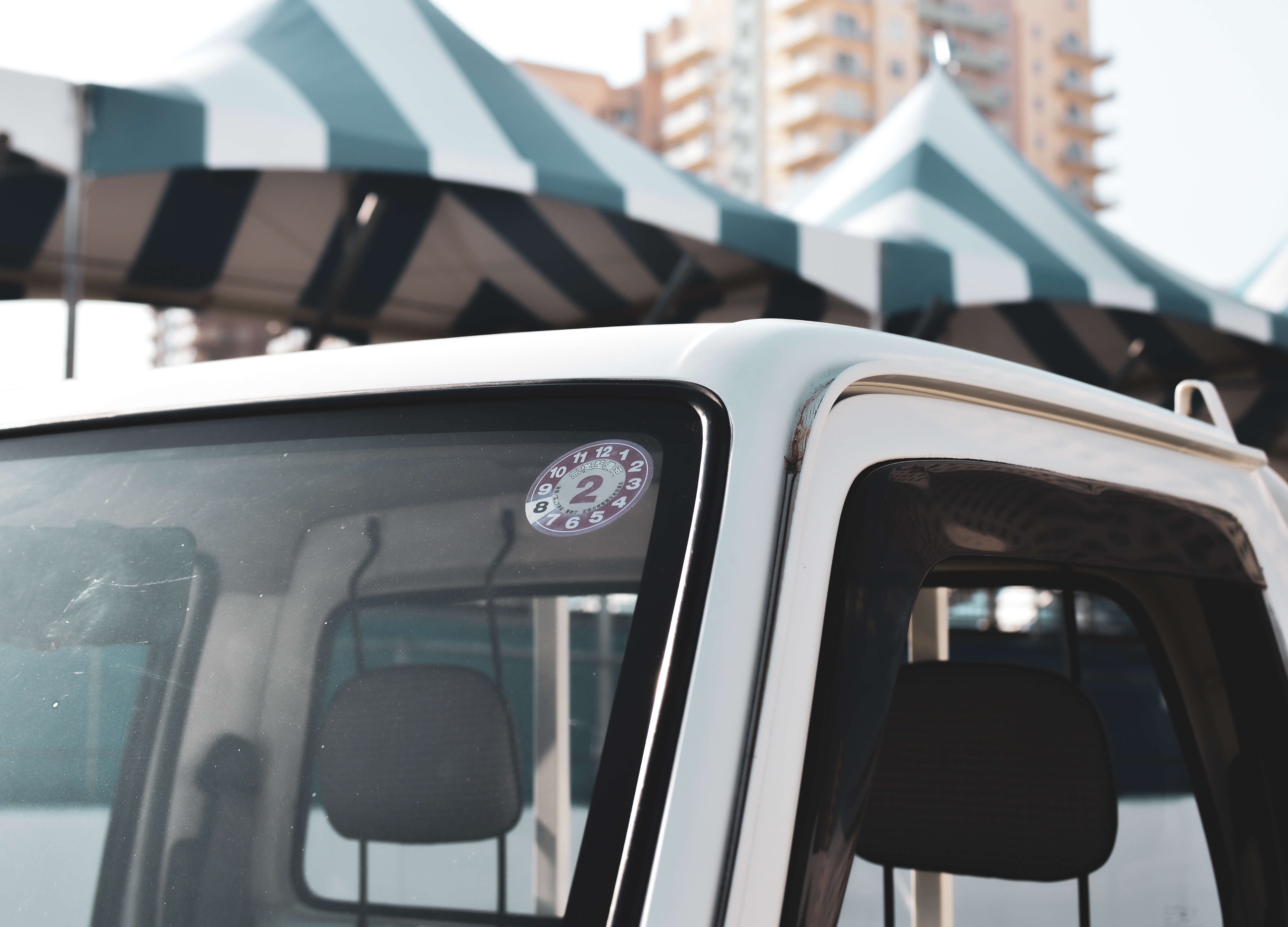 Kei truck roof rack on a white vehicle, enhancing transport utility and style.