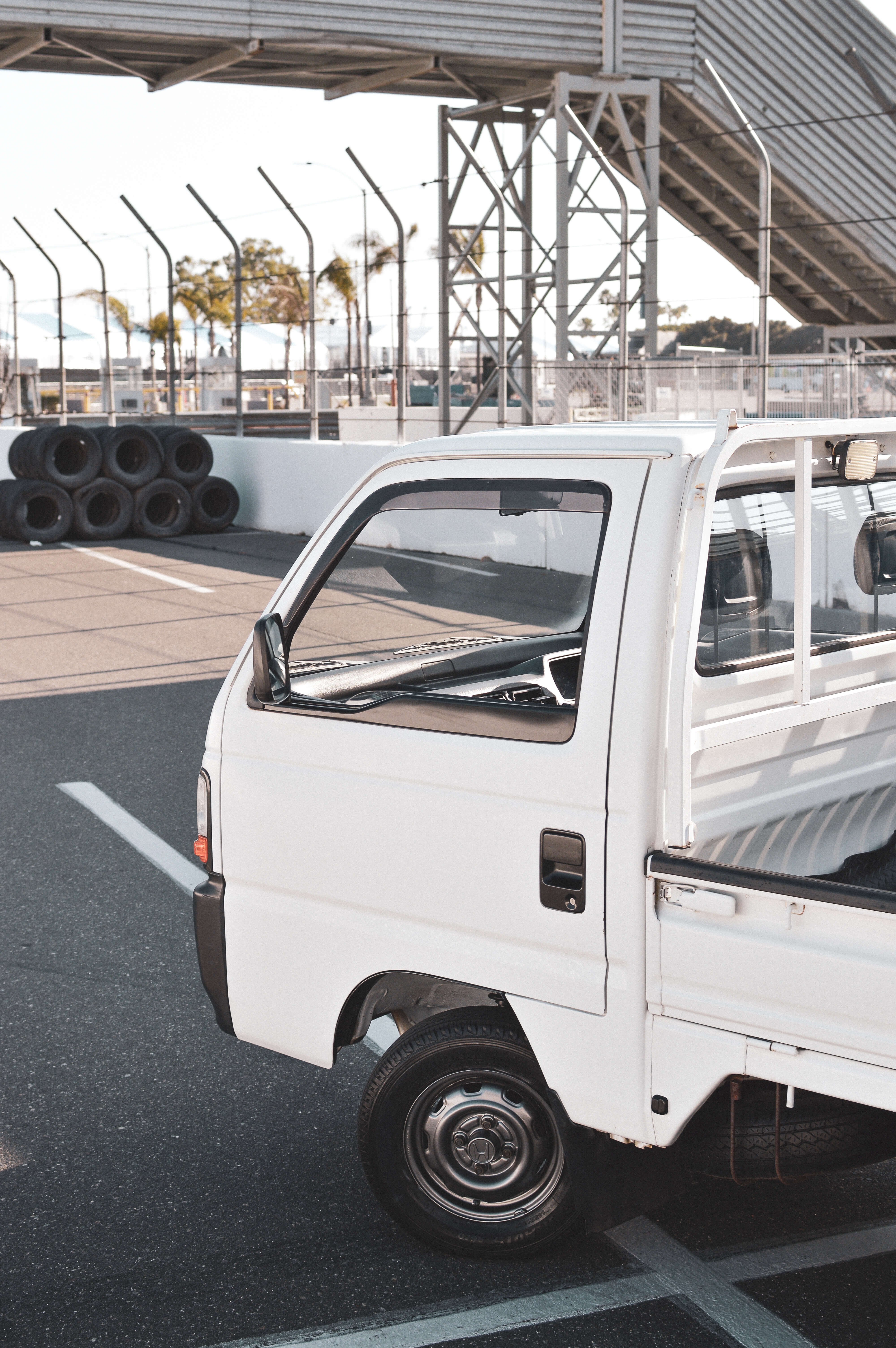 Sambar kei truck parked outdoors, showcasing Japanese engineering and efficiency.
