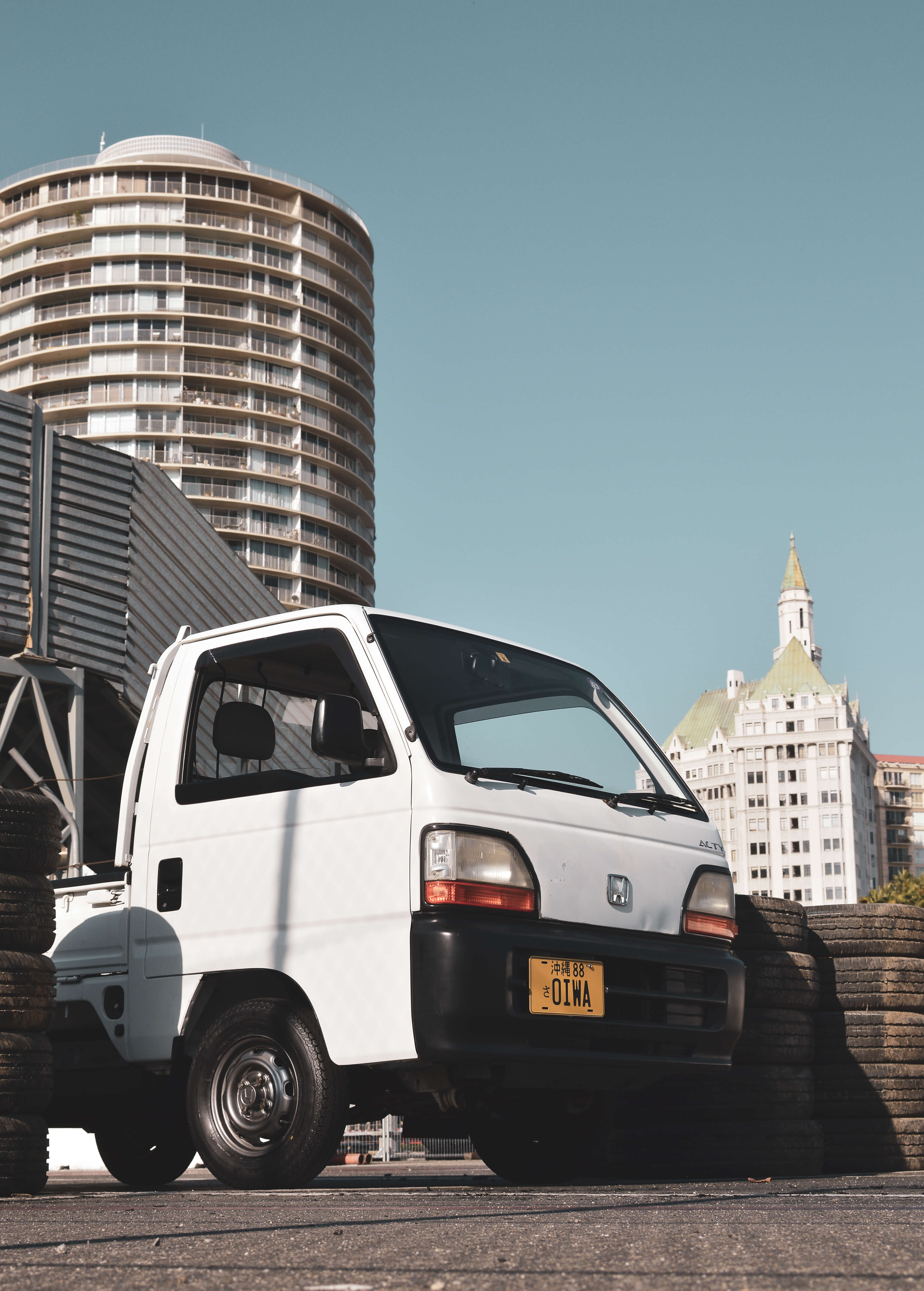 A kei truck parked under clear skies in Texas, illustrating its legal status on state roads.