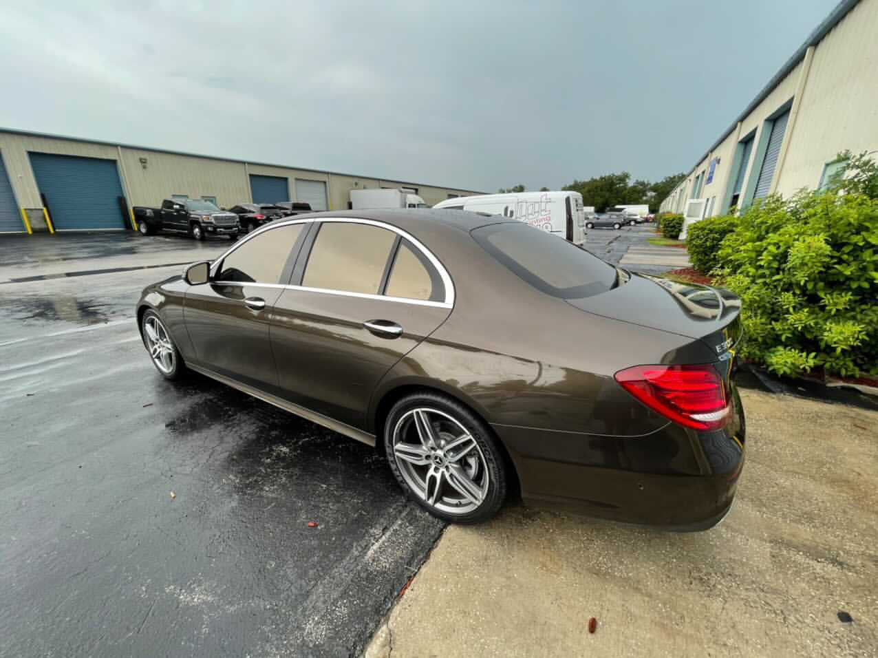 Green mirror tint on car window, enhancing style, UV protection, and privacy.