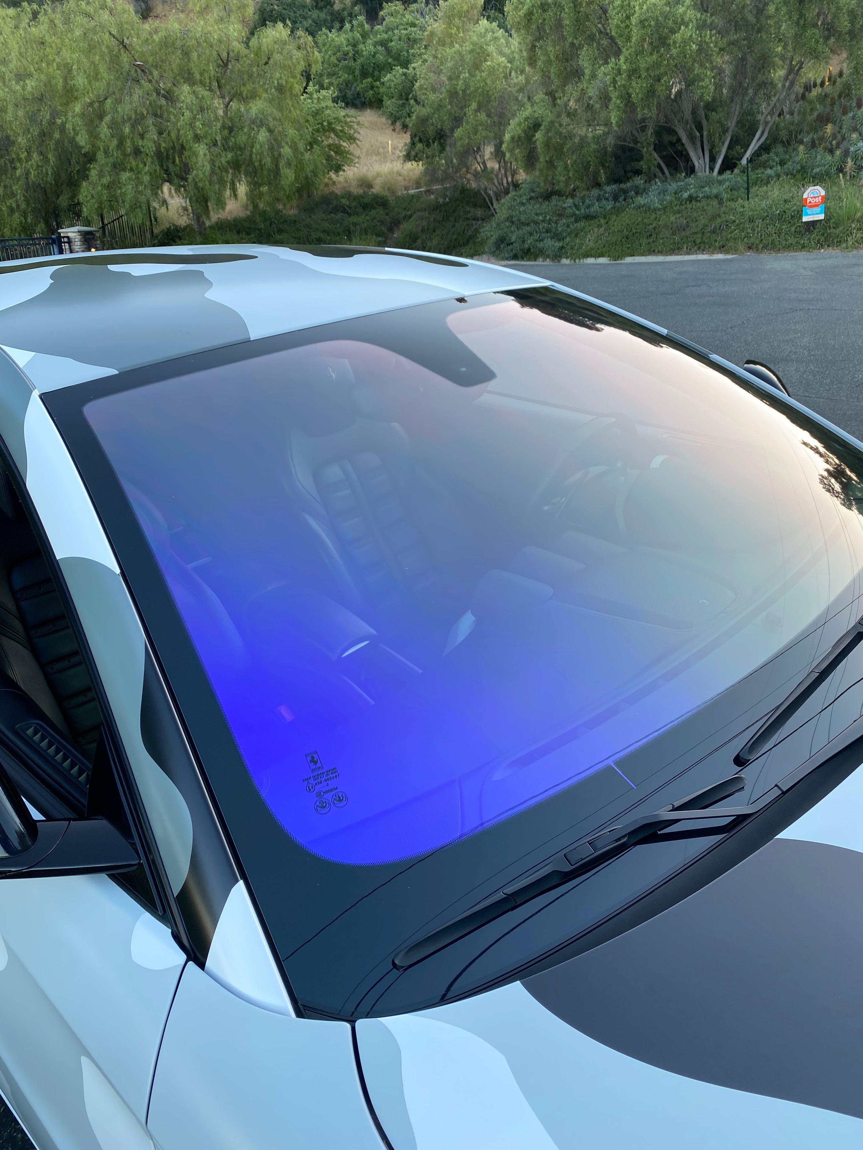 Luxurious car with gold tint windows offering UV protection and privacy.