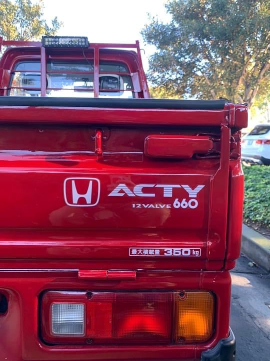Premium Reproduction Honda Acty 660 Tailgate Decal, showing the high-quality printing detail and perfect dimension match on a red Honda Acty truck, compatible with bed liner paints - Oiwa Garage.