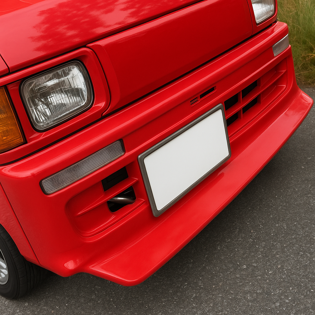 Close-up of a vibrant red Daihatsu Hijet S100V, S110V van featuring a sleek aftermarket body kit with a custom front bumper, clear rectangular headlights, and a Japanese license plate, ideal for enhancing style and aerodynamics.