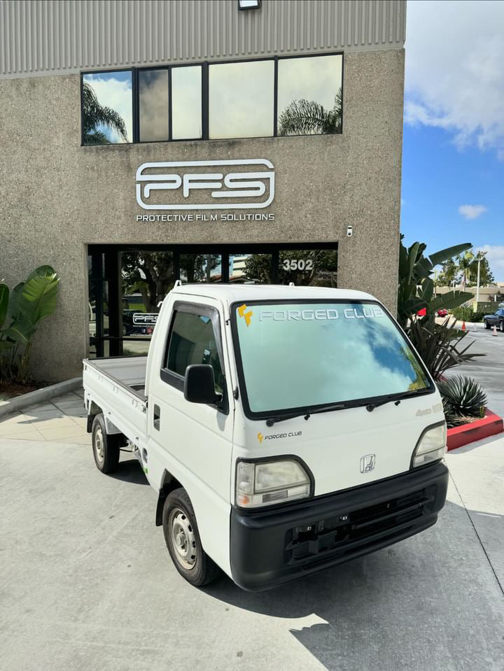 1997 Honda Acty featuring Omnique Window Tint for enhanced UV protection and sleek style, parked in front of PFS facility.