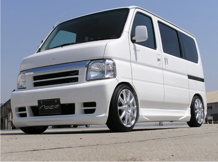 Honda Acty HH5, HH6 model from 1999-2009 equipped with a white custom body kit, featuring lowered stance, upgraded bumpers, and side skirts for a sporty, aggressive appearance.