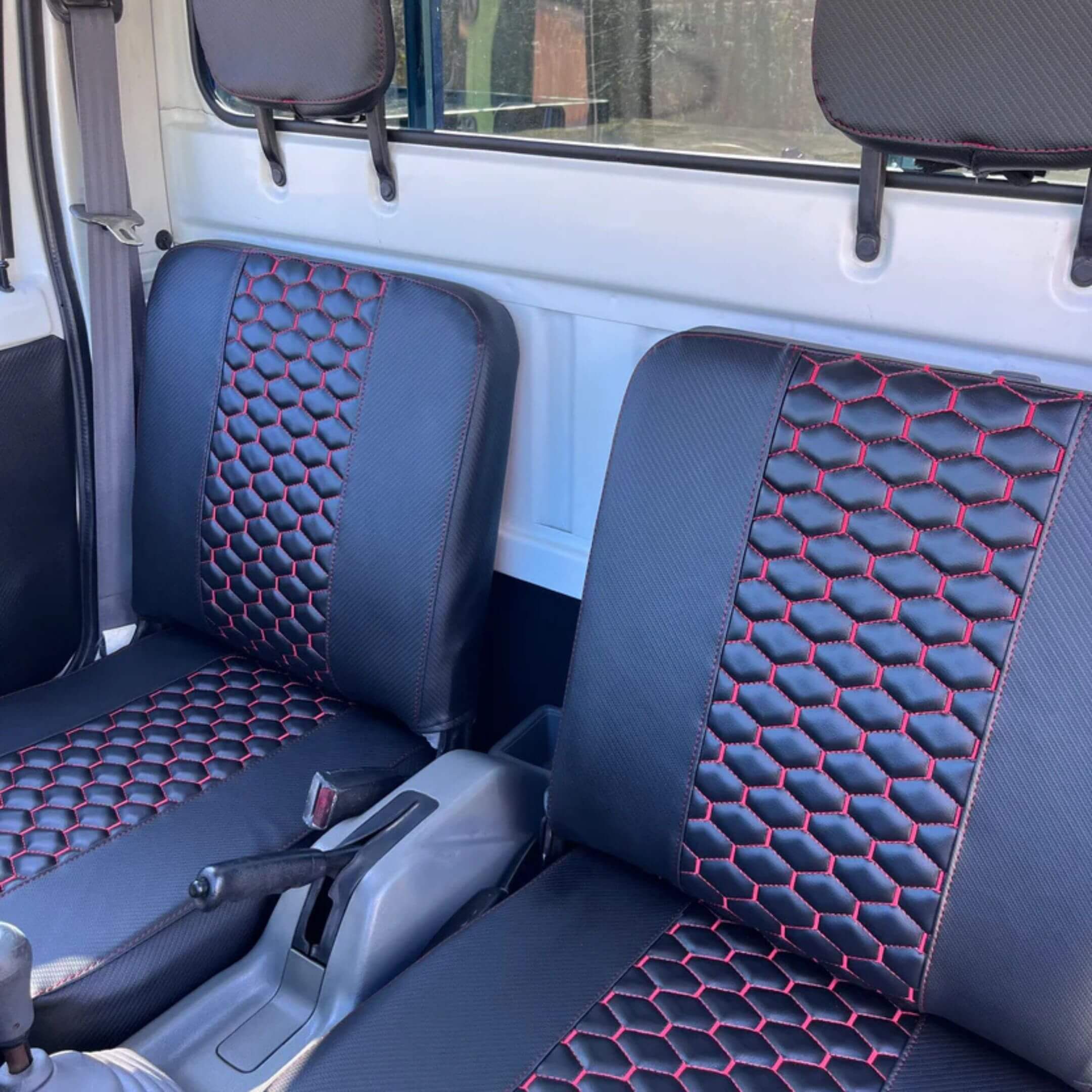 Honda Acty Seat Covers in Carbon Black with Red Honeycomb Stitching for HA3, HA4 Models (1990-1999) featuring driver and passenger seats.