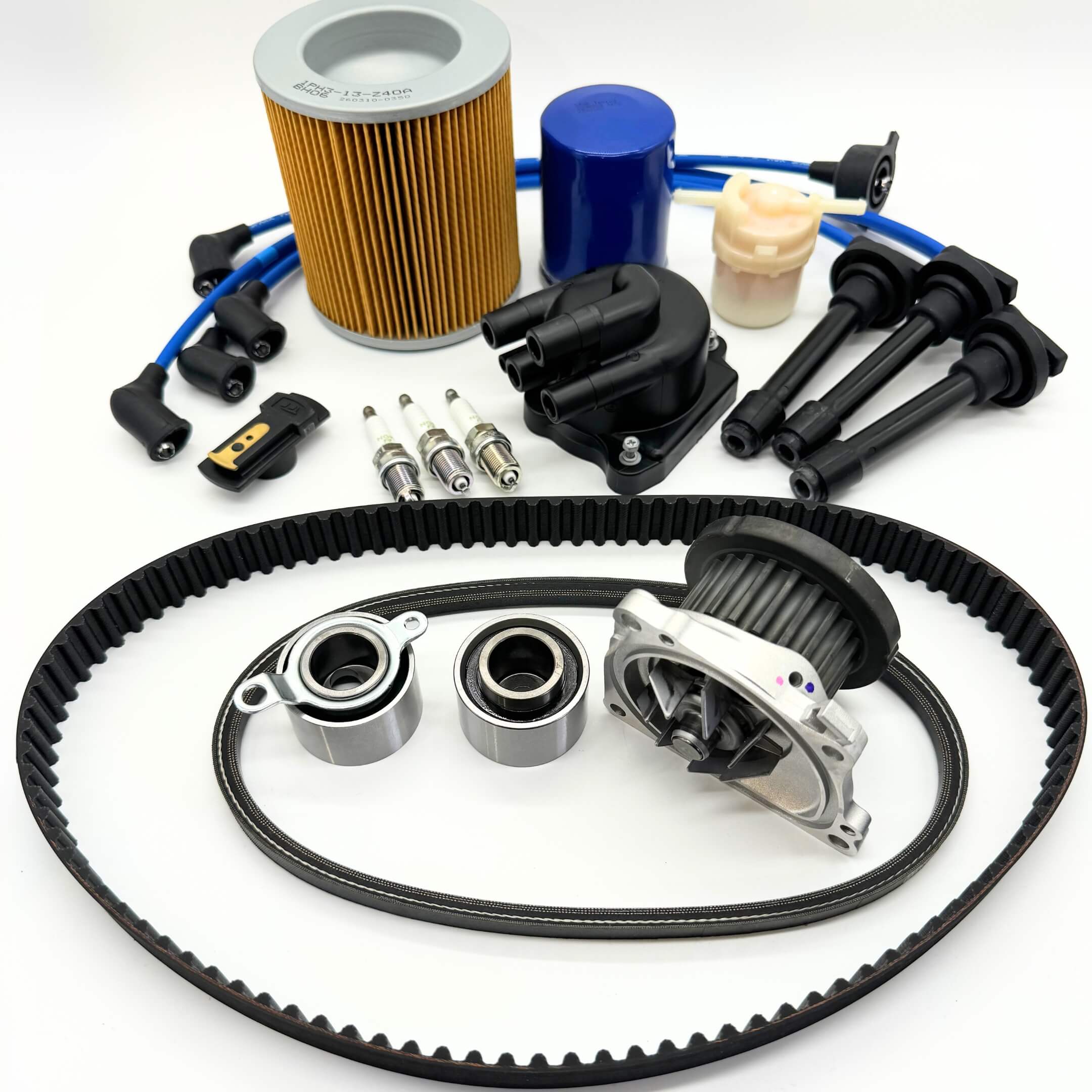 15-piece Honda Acty Timing Belt and Tune-Up Kit for HH3/HH4 models from 1990-1999, featuring air filter, fuel filter, oil filter, distributor cap and rotor, spark plugs with wires, timing belt, and alternator belt, expertly displayed on a white background, part of Oiwa Garage’s Exclusive Maintenance Mega Kit, available with free shipping.