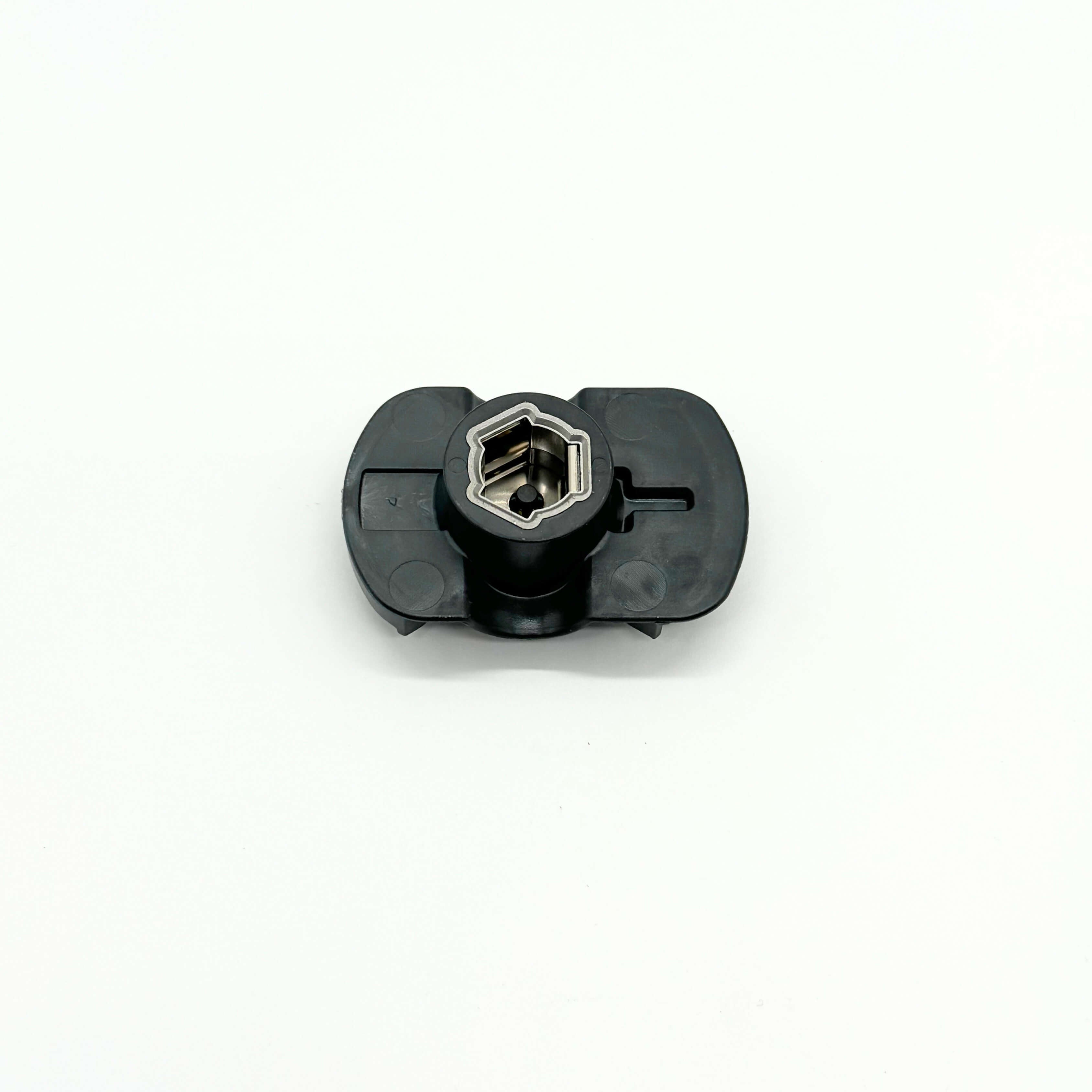 Bottom view of distributor rotor compatible with Suzuki Carry Truck DC51T, DD51T from 1991 to 1998, featuring unique star-shaped metal rotor inside black polymer body - precision-engineered for exact fitment and reliable conductivity.