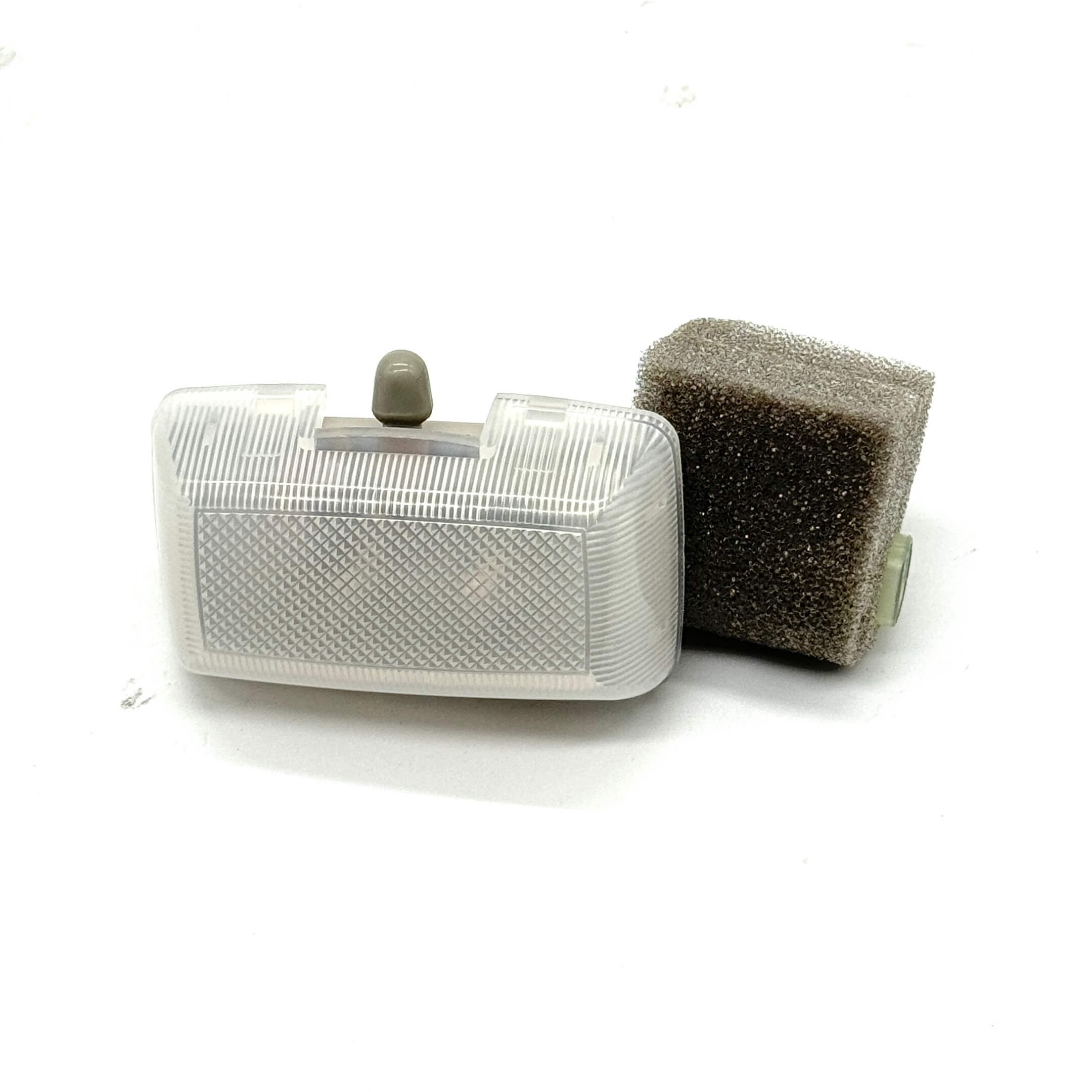 Angled view showcasing the compact design of the Subaru Dome Light Assembly with foam padding.