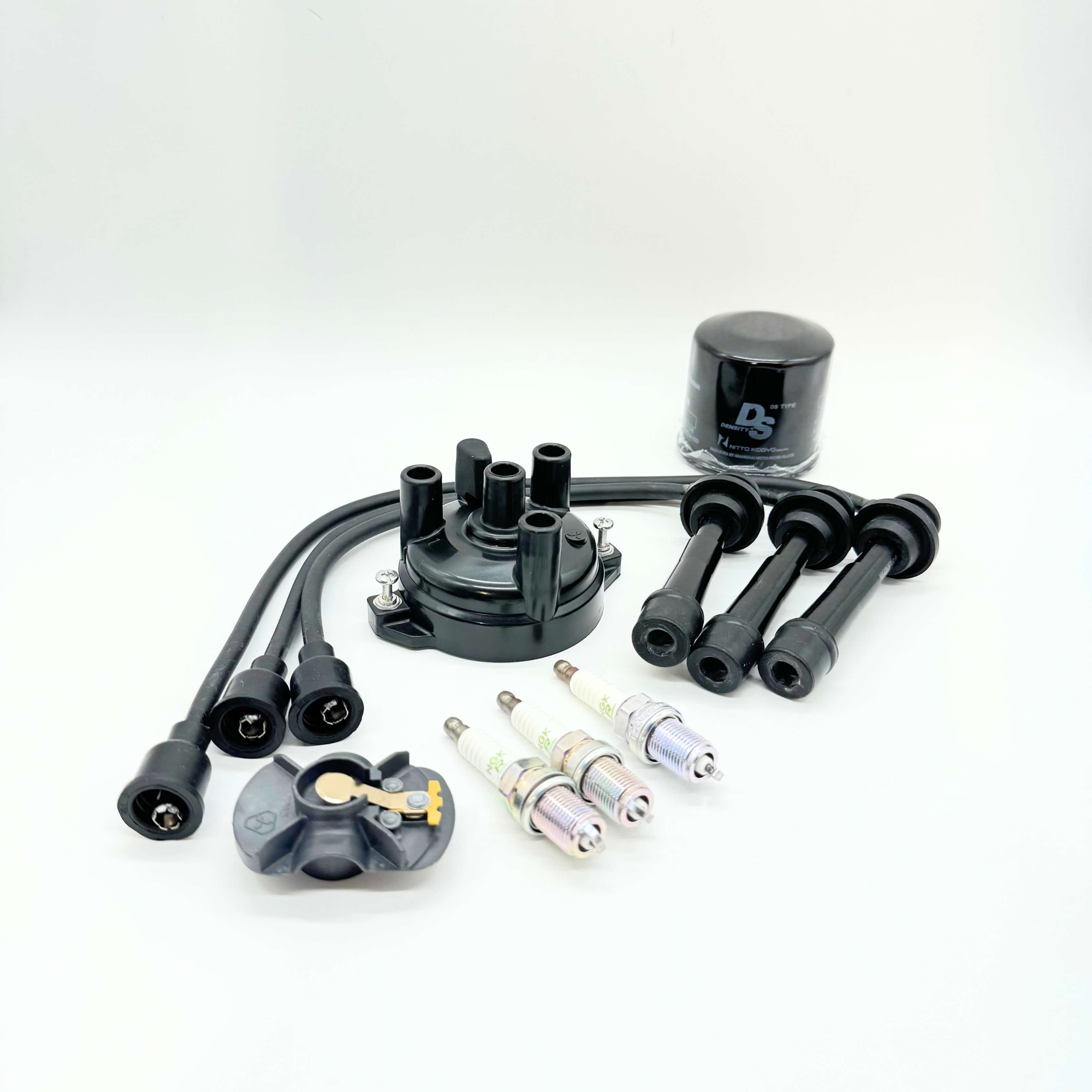 Complete 9-Piece Ignition Kit for Suzuki Carry Truck DC51T, DD51T Models (1991-1998), including a high-quality distributor cap, three spark plugs, spark plug wires set, and an oil filter for comprehensive engine maintenance.