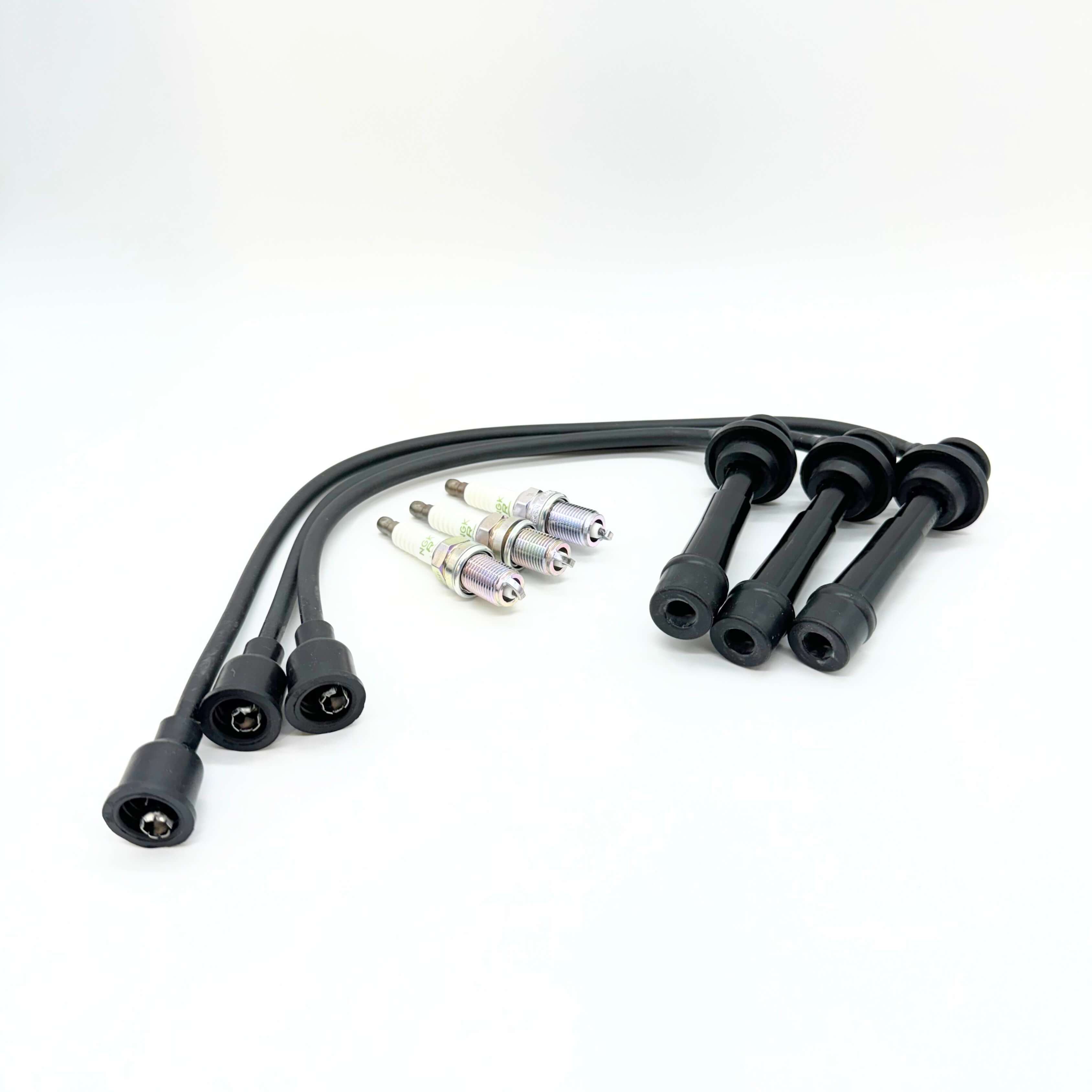 Replacement spark plugs and ignition wires set for Suzuki Carry Truck DC51T, DD51T models from 1991 to 1998, showcasing high-quality electrodes and durable wire insulation for improved conductivity and engine performance.