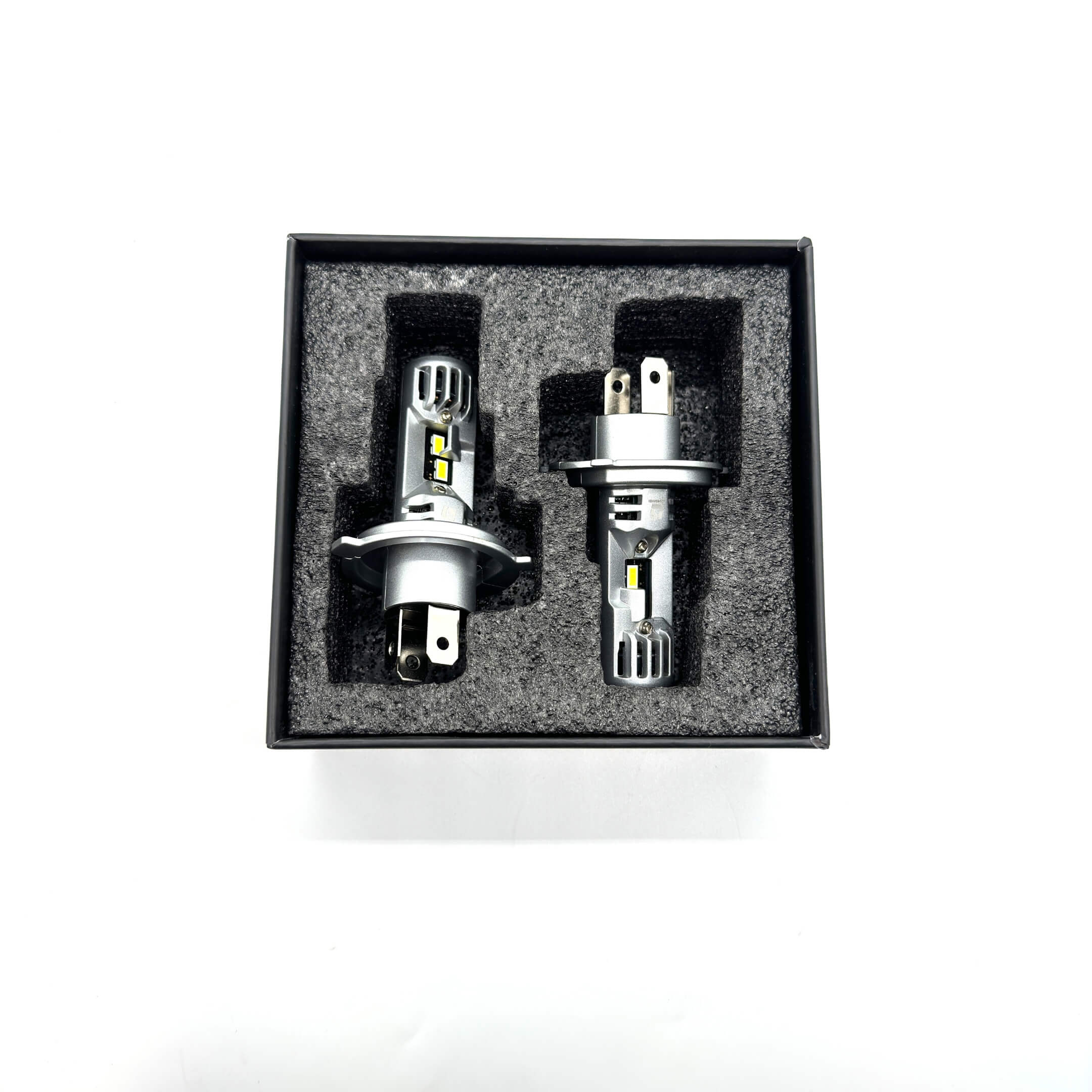 Premium packaging of LED headlight bulbs for Subaru Sambar, displaying the product's robust casing and secure placement in a foam insert.