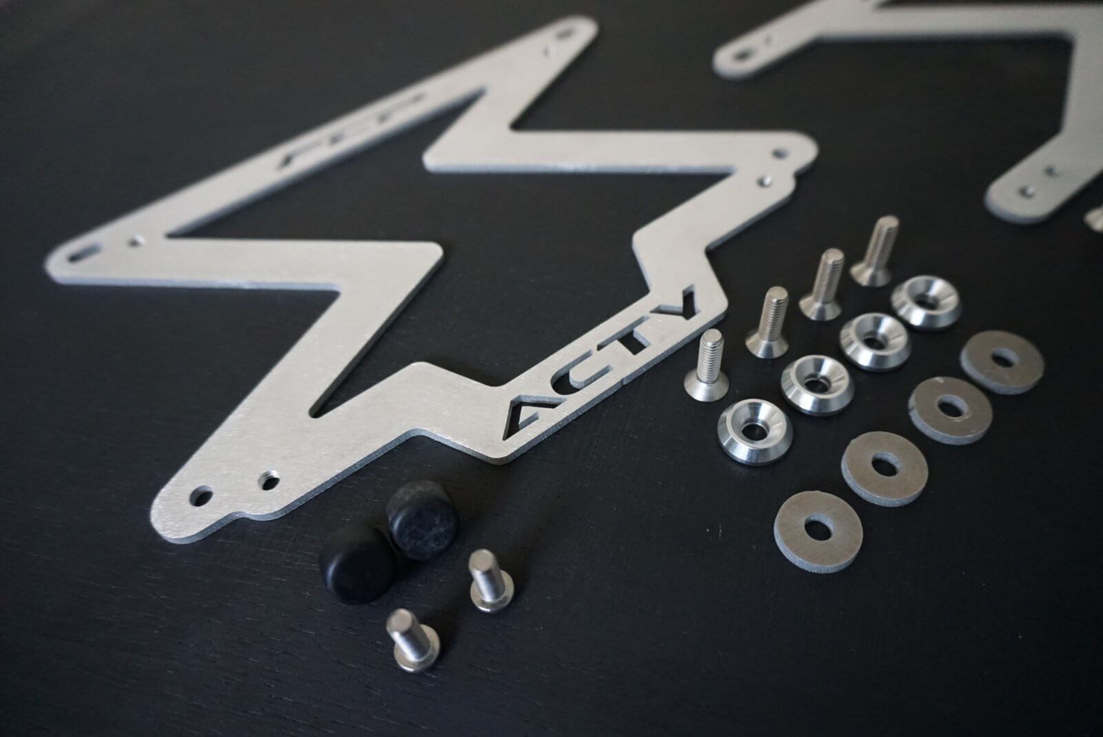 High-quality water-jet cut aluminum license plate adapter for Honda Acty, providing a sleek USDM mounting solution without drilling, including hardware.