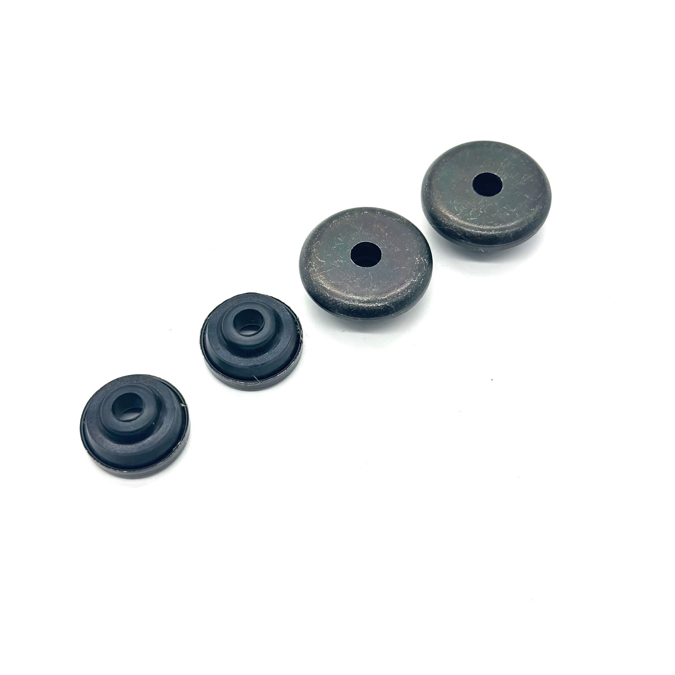 Black Valve Cover Bolt Seal Set featuring four round seals for secure engine assembly.