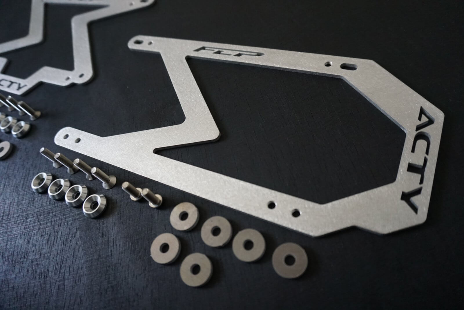 Close-up of the precision-cut aluminum license plate adapter for Honda Acty Vans & Vans, highlighting the seamless fit and no-drill installation.
