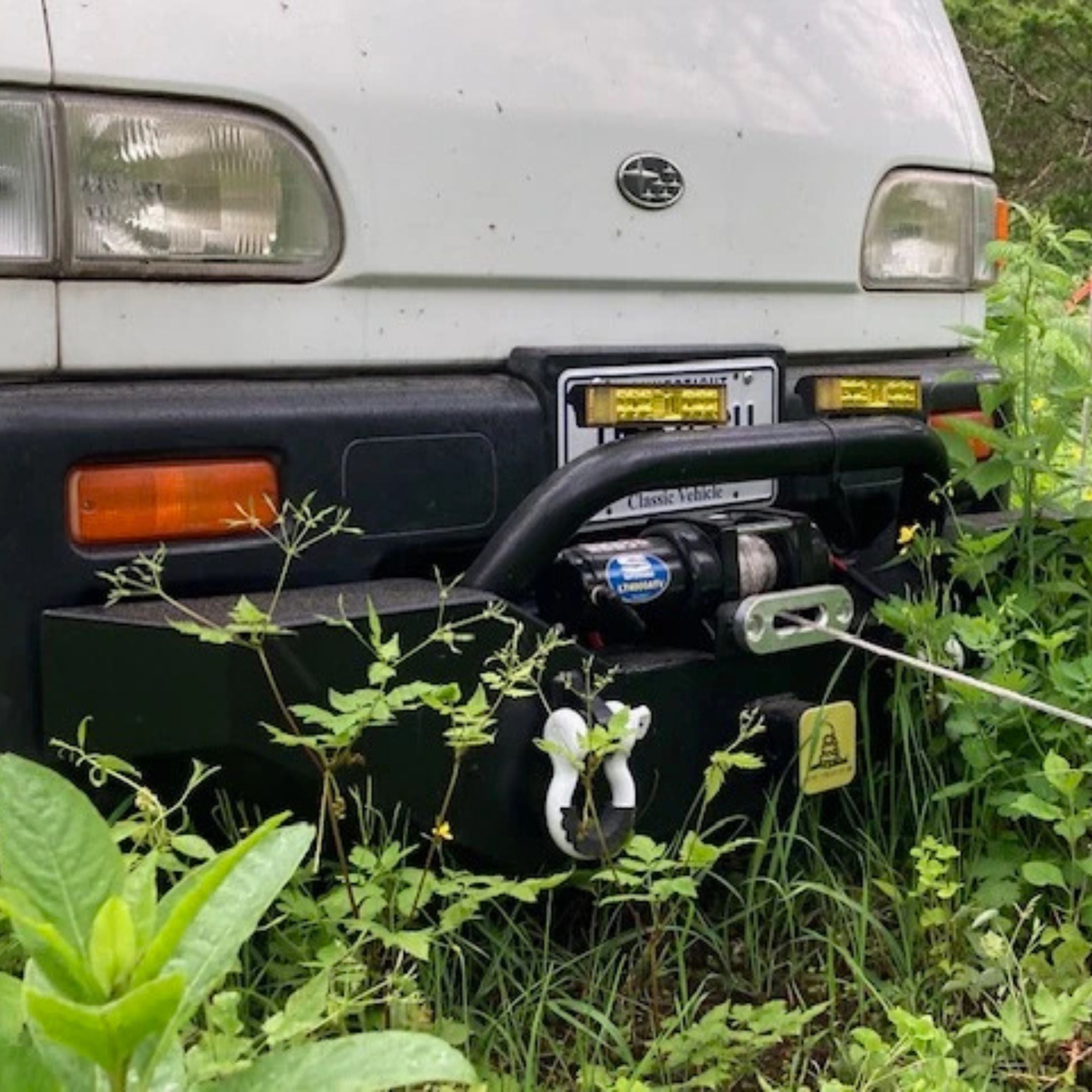 Close-up of XPERT Series Armor Front Bumper installed on Subaru Sambar KS3 with winch cable engaged.