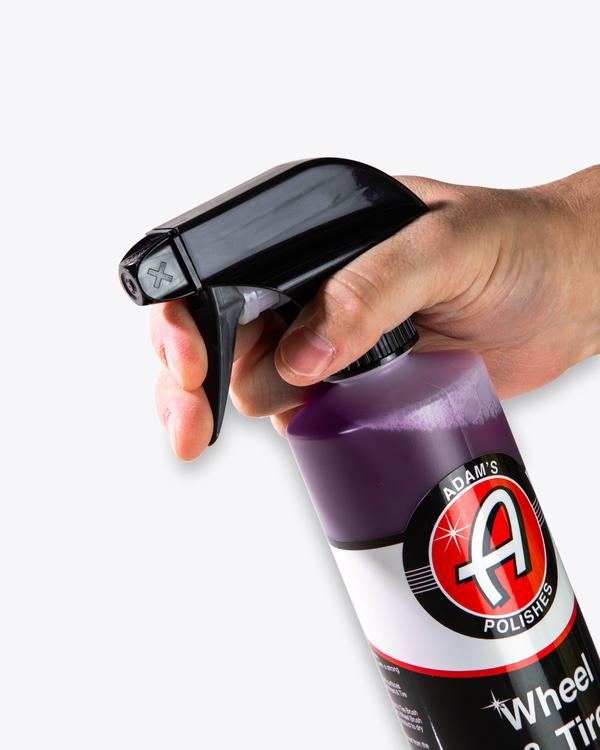 Best Car Detailing Kit showing Adam’s Polishes Wheel & Tire Cleaner being sprayed, providing powerful brake dust and grime removal for daily drivers.