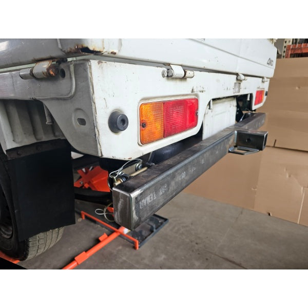 Suzuki Carry Rear Baird Bumper DD51T Model 1991-1999, featuring a durable metal design with integrated tail lights.