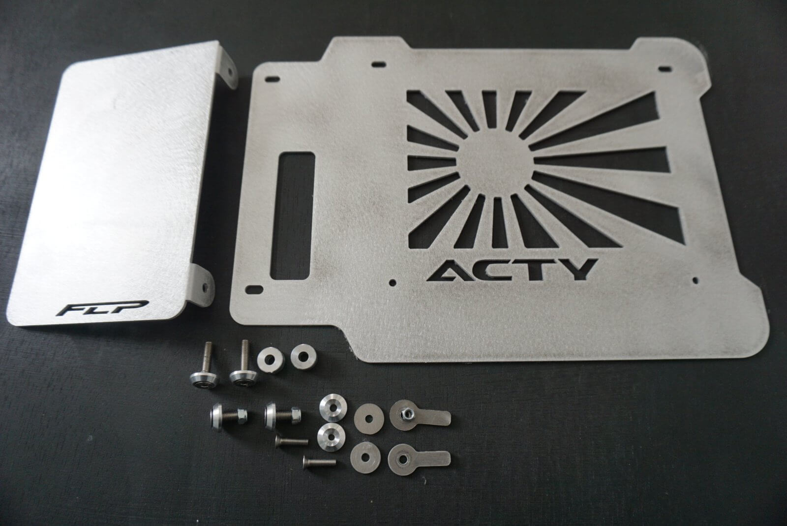 Rising Sun Battery Cover for Honda Acty Truck, featuring a silver metal design with cut-out sun rays and logo, includes mounting hardware