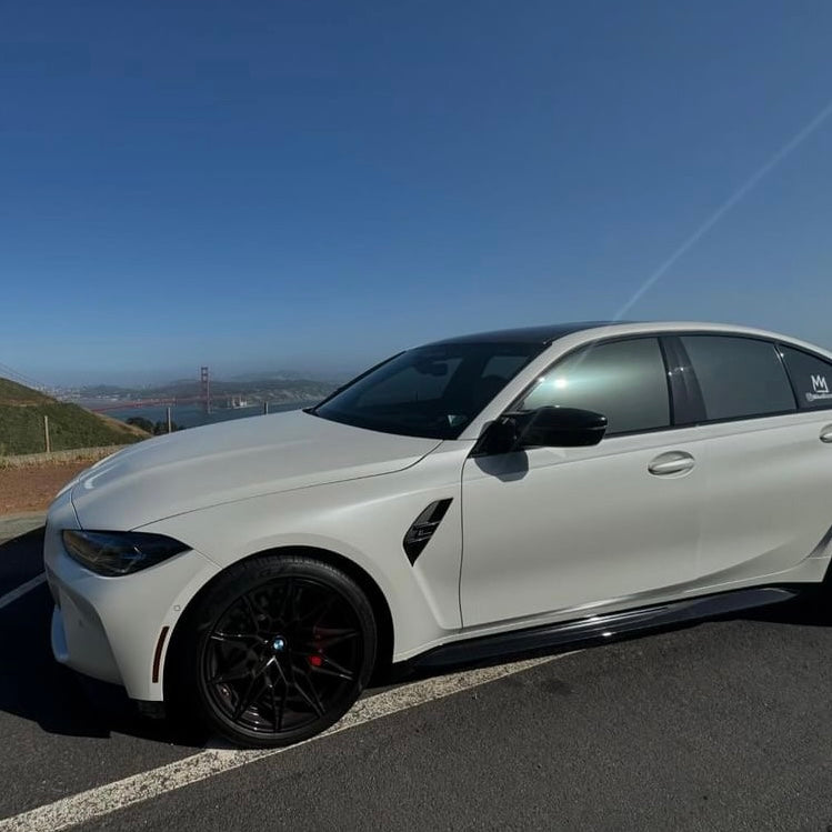 BMW M3 with Nebula Black window tint by Omnique, highlighting a reflective black finish.