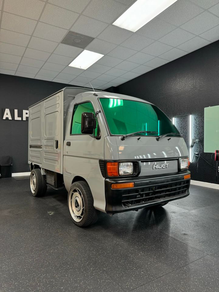 Peridot Green Tint Applied to Daihatsu Hijet: Peridot green one-way mirror tint on the front windows of a classic Daihatsu Hijet.
