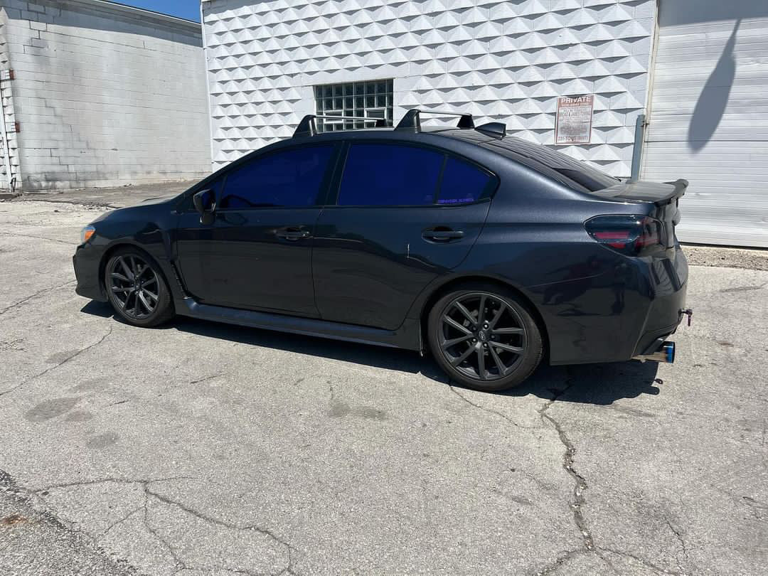 Black Sedan with Omnique Amethyst Purple Tint – Sleek black car featuring Omnique’s ultra-dark 5% VLT Amethyst Purple tint.