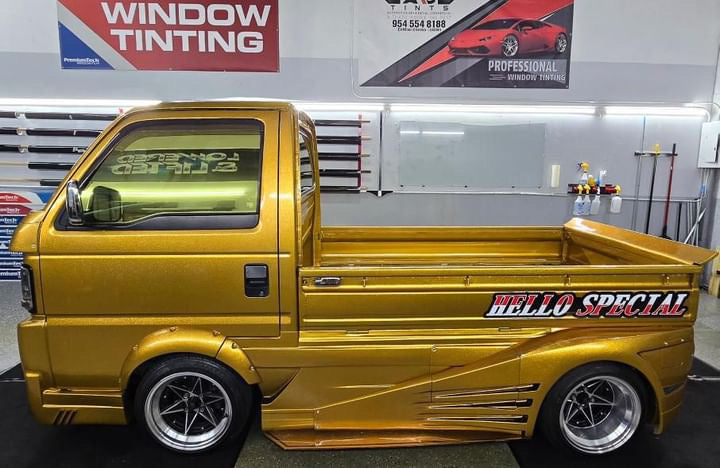 Gold-tinted Honda Acty with Phantom Gold film applied to the side and rear windows.