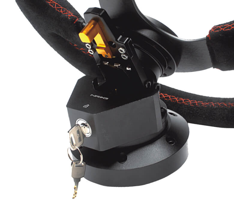 Installed NRG Steering Wheel Quick Tilt System with Lock - Black SRK-100BK, showcasing the orange release lever and integrated lock with key.