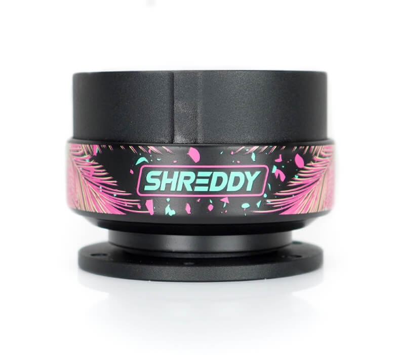 Close-up of NRG Quick Release Gen 2.0 SRK-200BK-SDY2 with Shreddy collab, featuring Shreddy logo, black body, and palm leaves design.