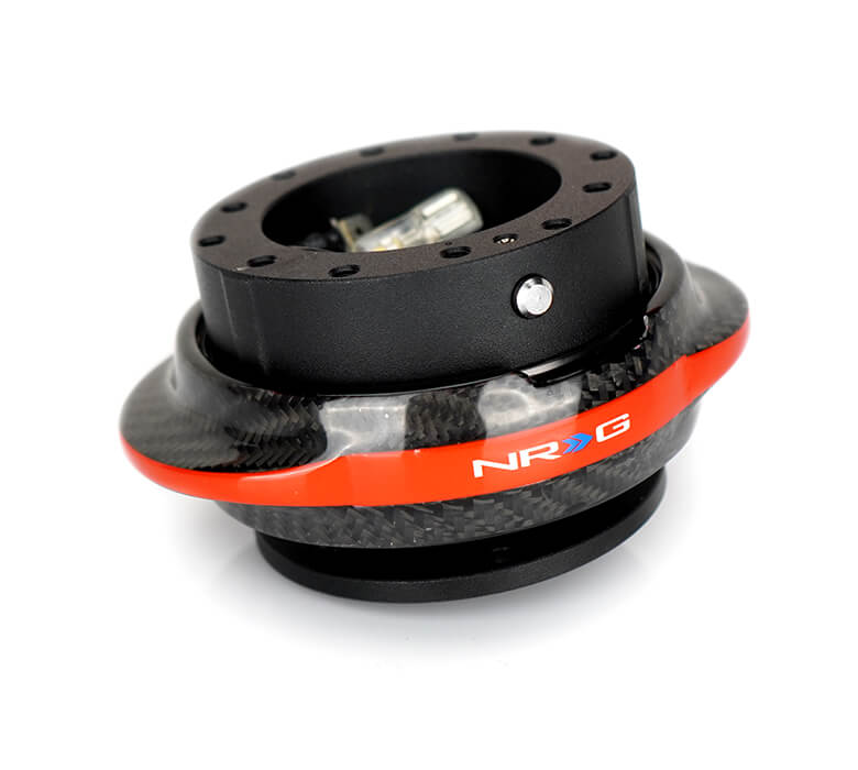 Angled view of the NRG Quick Release Kit - Black Body / Carbon Fiber Red Ring - Gen 2.2 - SRK-220BK-CF/RD, emphasizing the precise design and stylish black finish with a red accent.