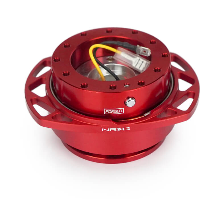 Angled view of NRG Quick Release Kit SRK-257RD-RD with red body, cutout ring, and detailed wiring.