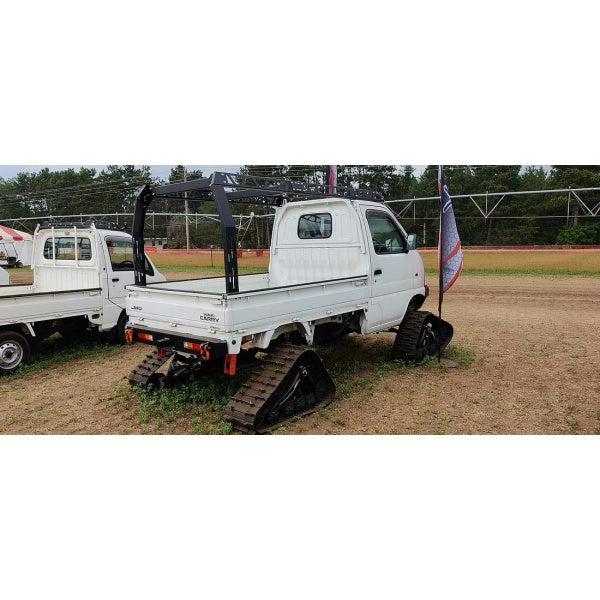 Suzuki Carry DB52T Model 1999-2002 with white ladder rack and roof rack, featuring track conversion for off-road capability.