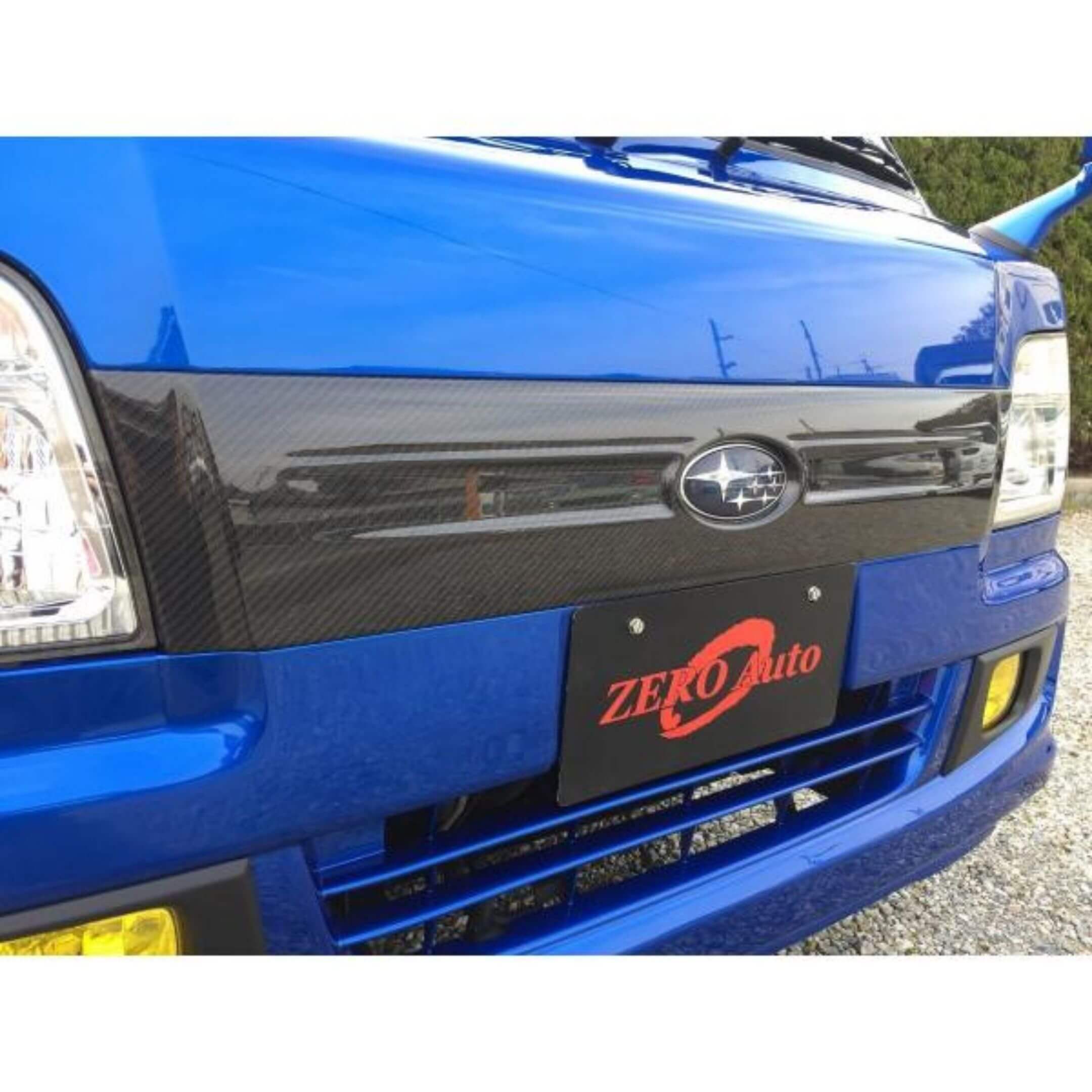 Carbon Fiber Grill Cover by Zero Auto for Subaru Sambar Truck TT1, TT2 Models (2005-2009) featuring a sleek carbon fiber design.