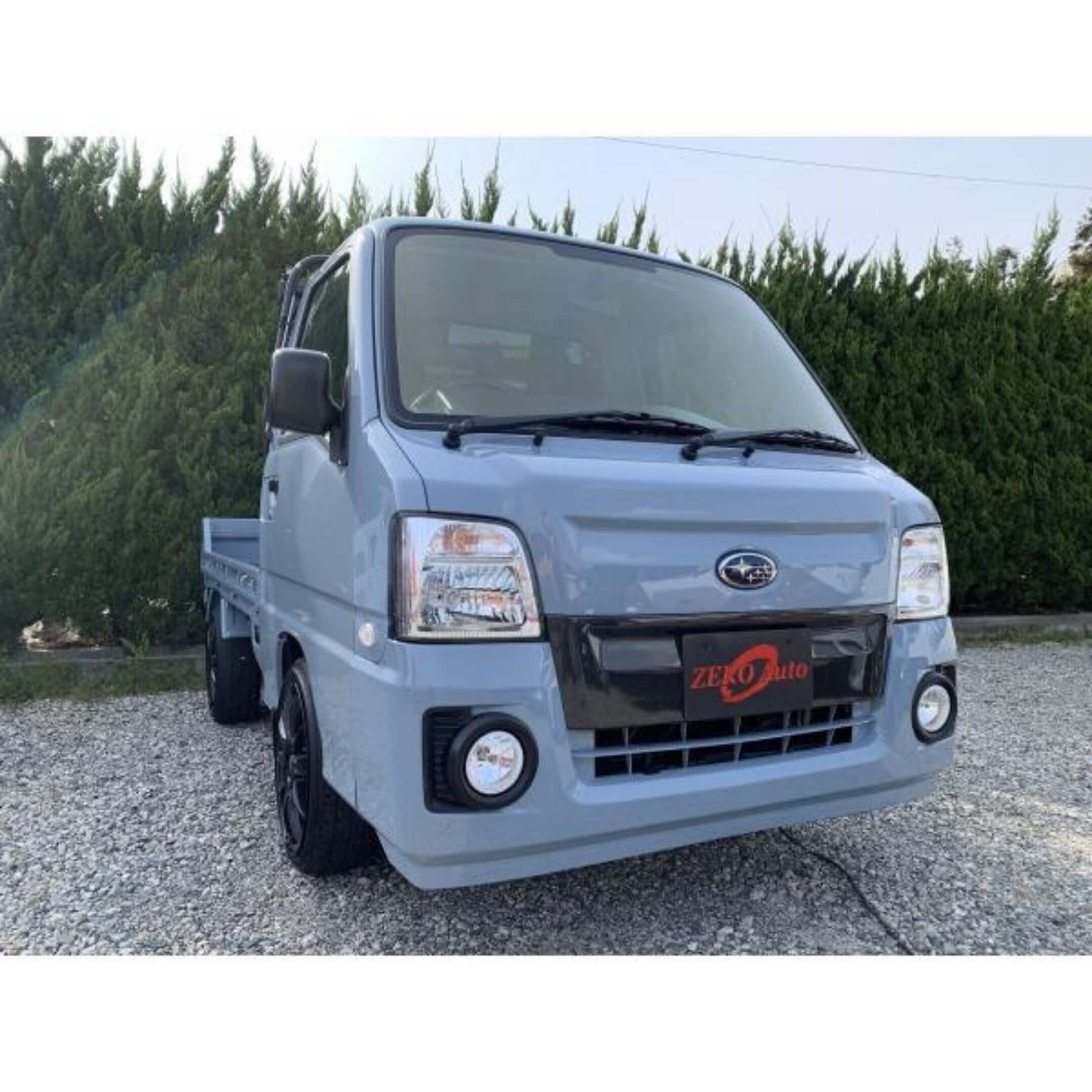 Front Bumper Carbon Fiber Cover by Zero Auto for Subaru Sambar Truck TT1, TT2 Models (2009-2012) featuring sleek design and enhanced durability.
