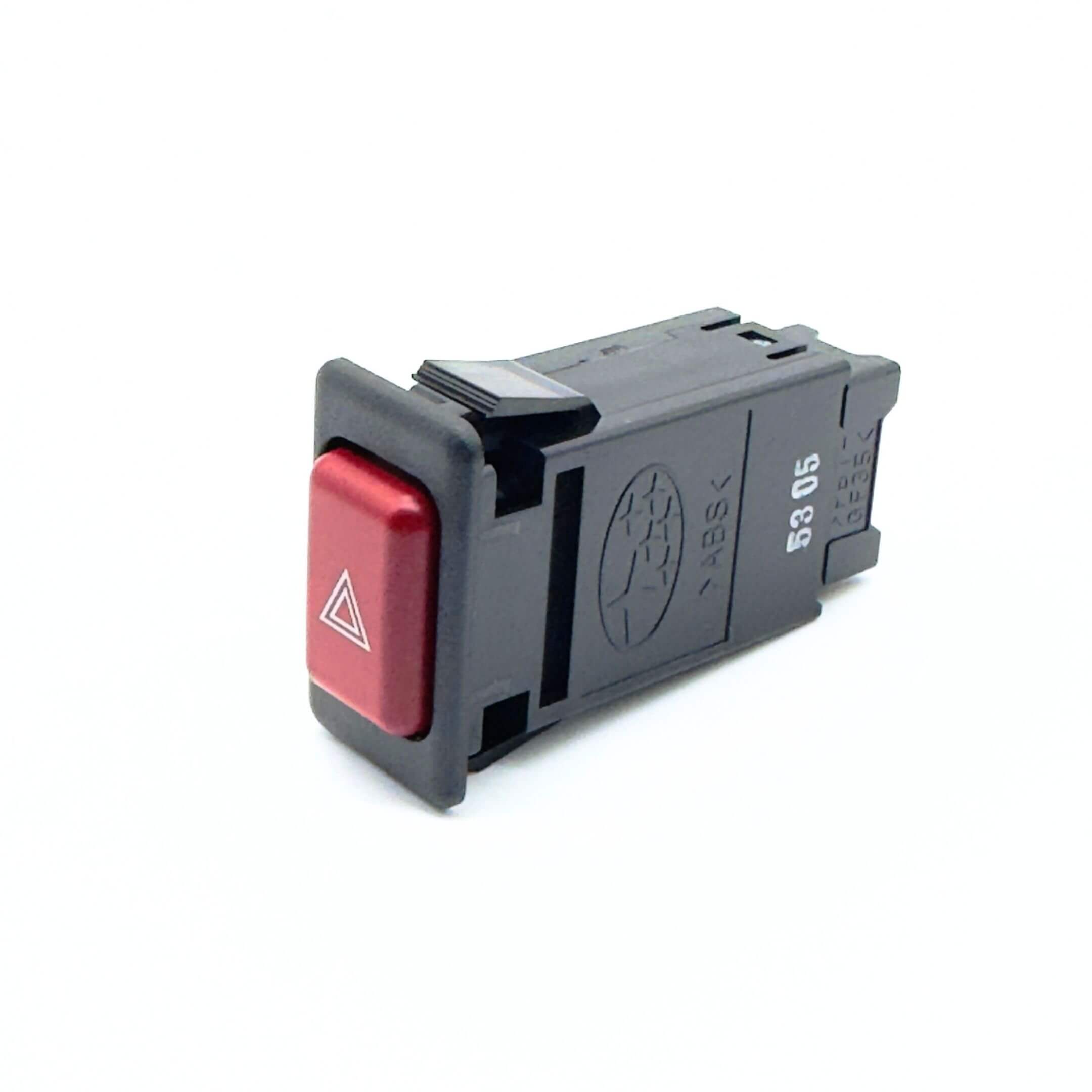 Hazard Lights Button Assembly for Subaru Sambar Truck TT1, TT2 Models (1999-2012) featuring a red triangular warning symbol on a black casing.