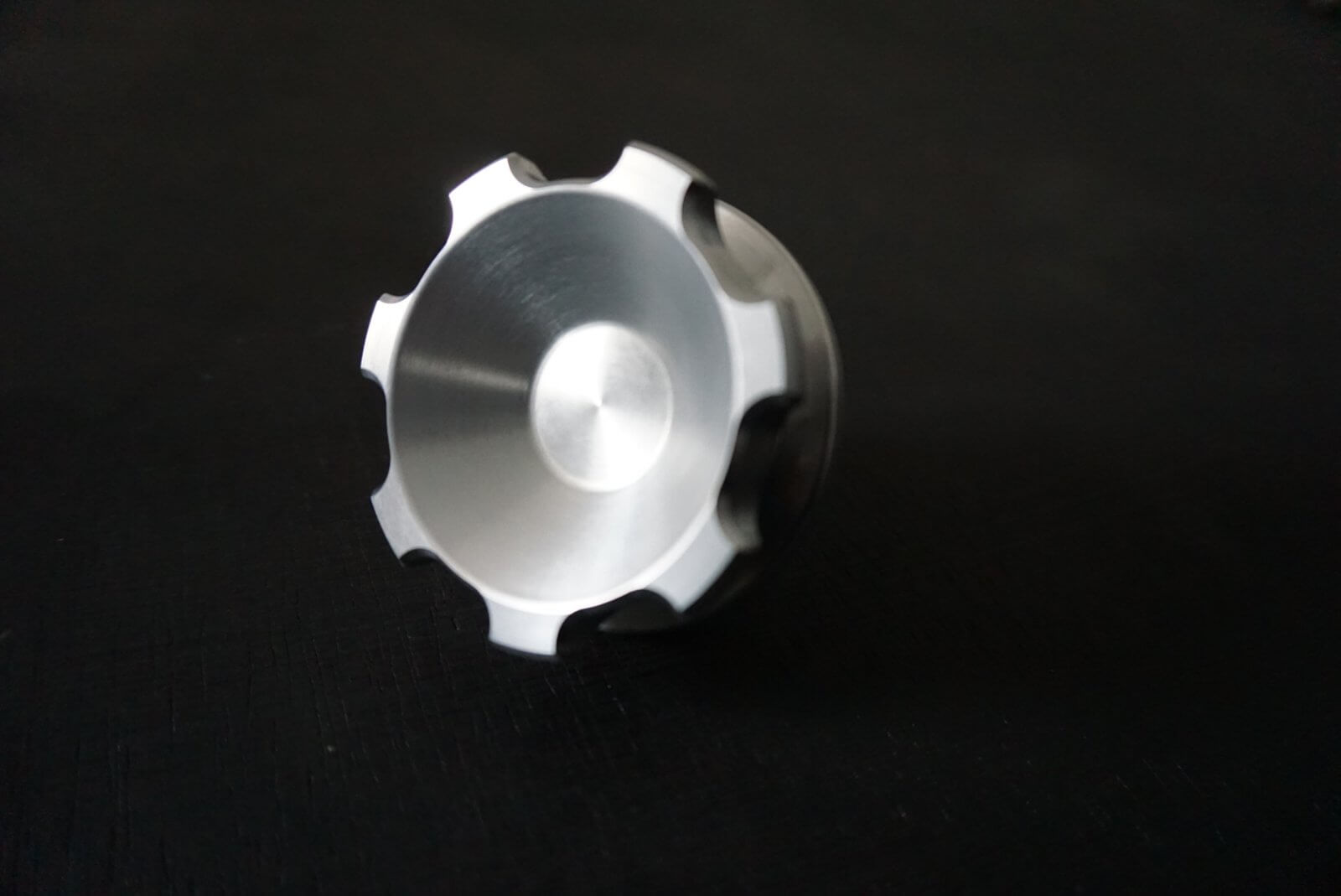 Crown gas cap for Honda Acty Truck, silver aluminum, showcasing a rounded design with grooves, set against a dark background