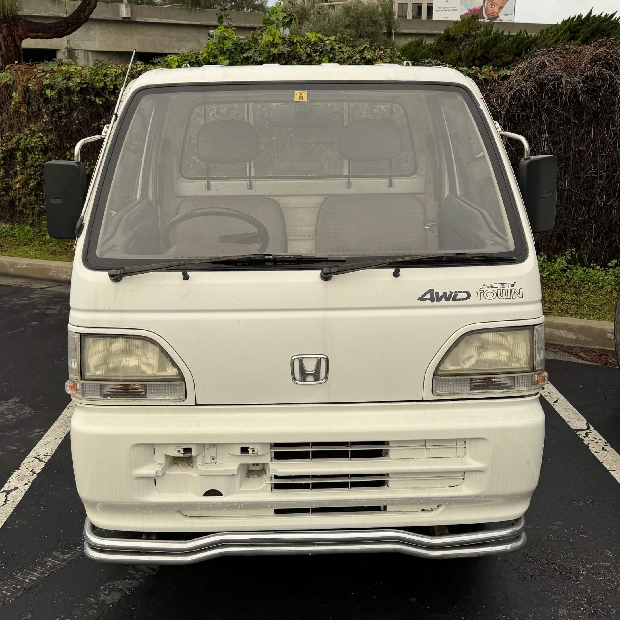 Front view of 1994 Honda Acty Town 4WD Kei Truck in white, clearly displaying headlights, windshield, and original Honda badge.