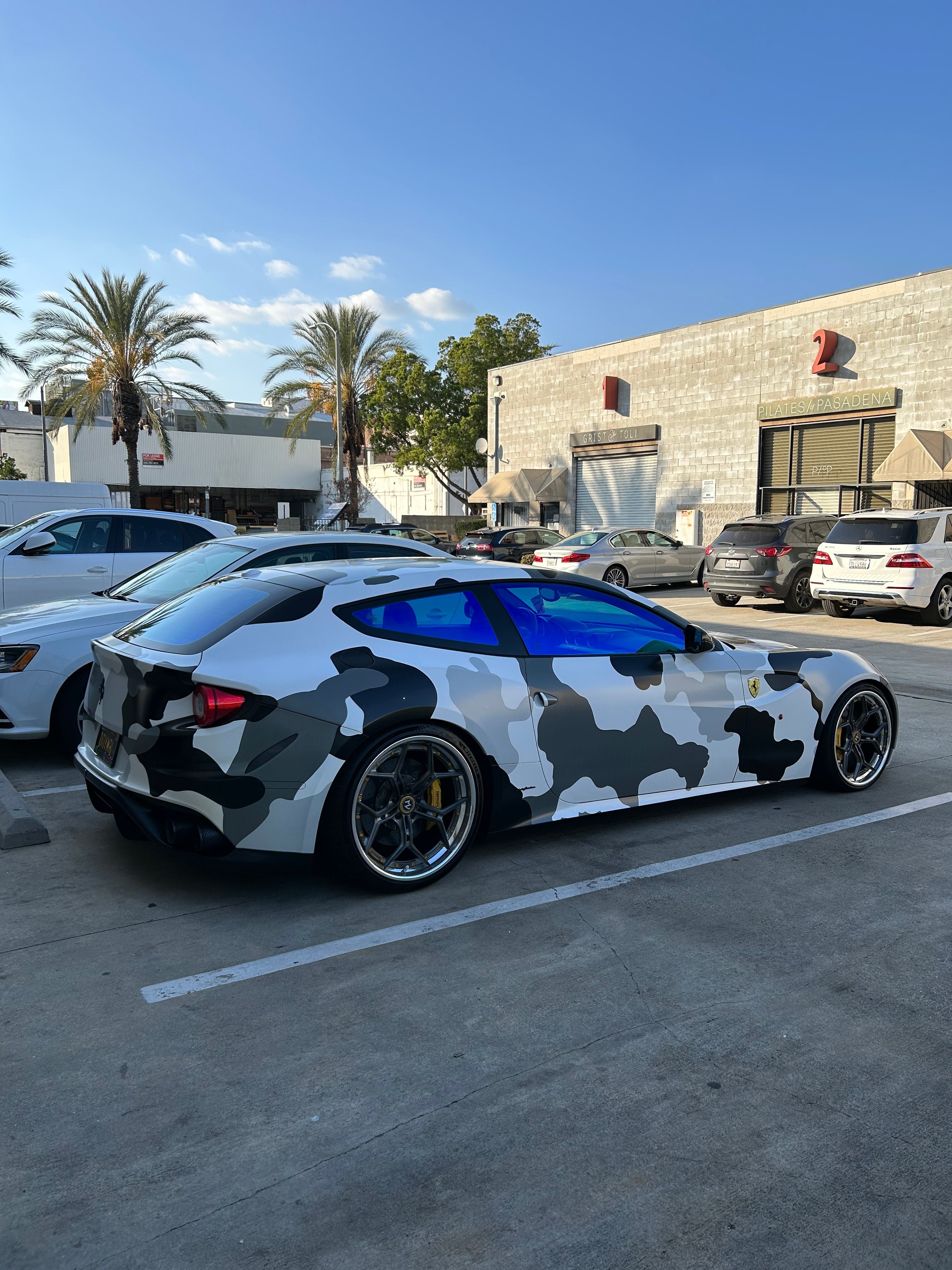 Camouflaged coupe with Omnique Zircon Tint, illustrating a perfect blend of style and UV protection.