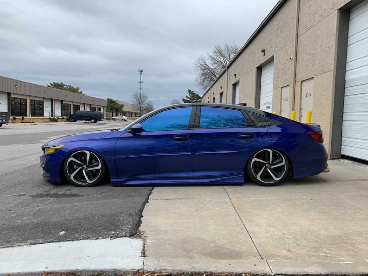 Sleek blue sedan with Omnique Zircon Tint, featuring a gentle blue-shifted tint across all windows.