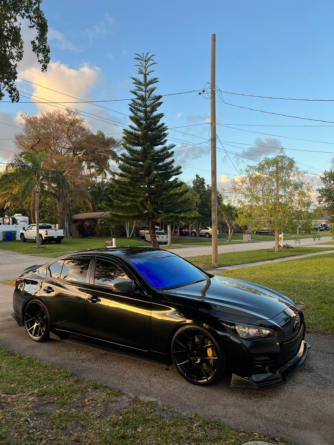 Black sports car with Omnique Zircon Tint, highlighting its cool blue tint on the windshield.