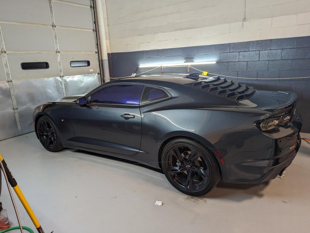 Camaro with Omnique Amethyst Purple Tint – Dark Omnique mirror tint applied to a Camaro for enhanced privacy and aesthetics.