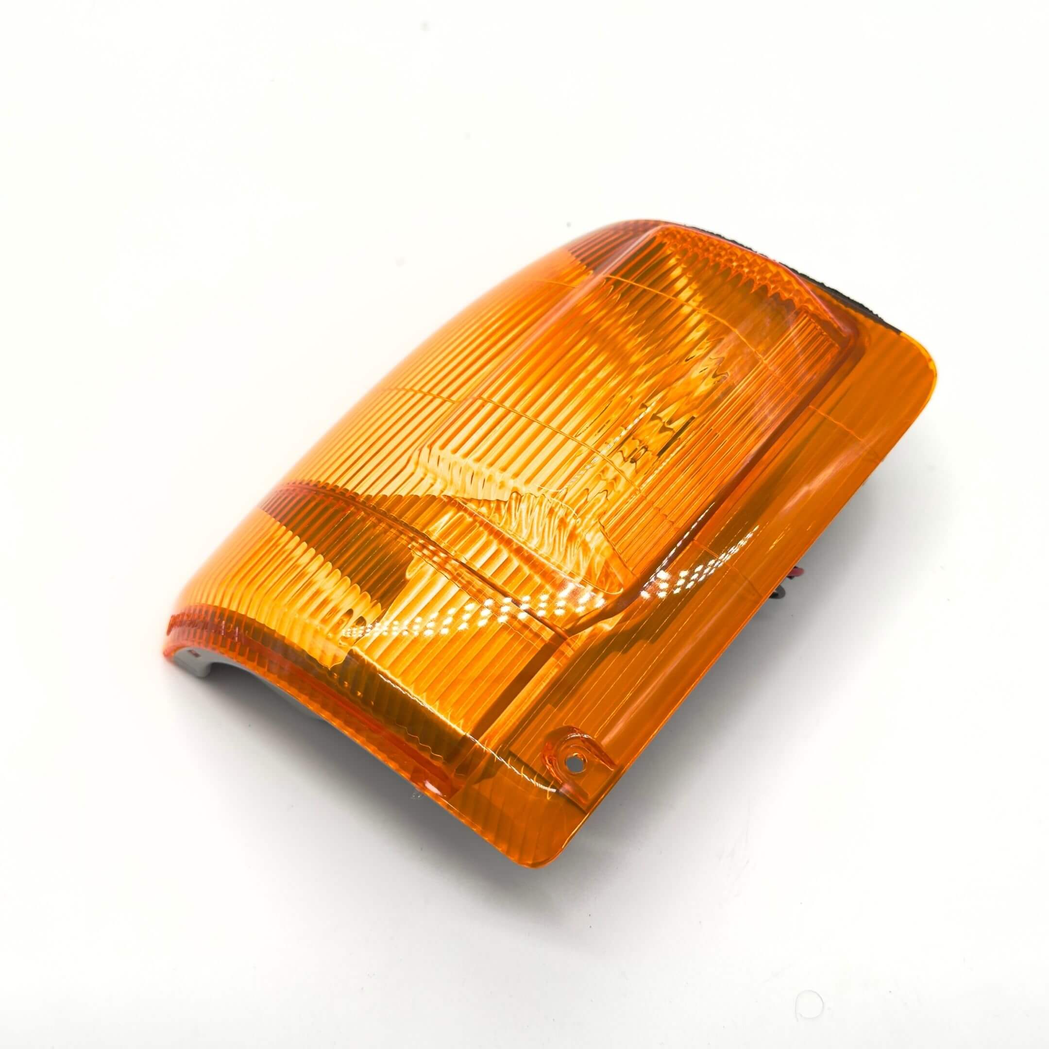 Front Turn Lamp Assembly - Left / Passenger Side for Subaru Sambar Truck TT1, TT2 Models (1999-2012) featuring an amber lens with a ribbed design.