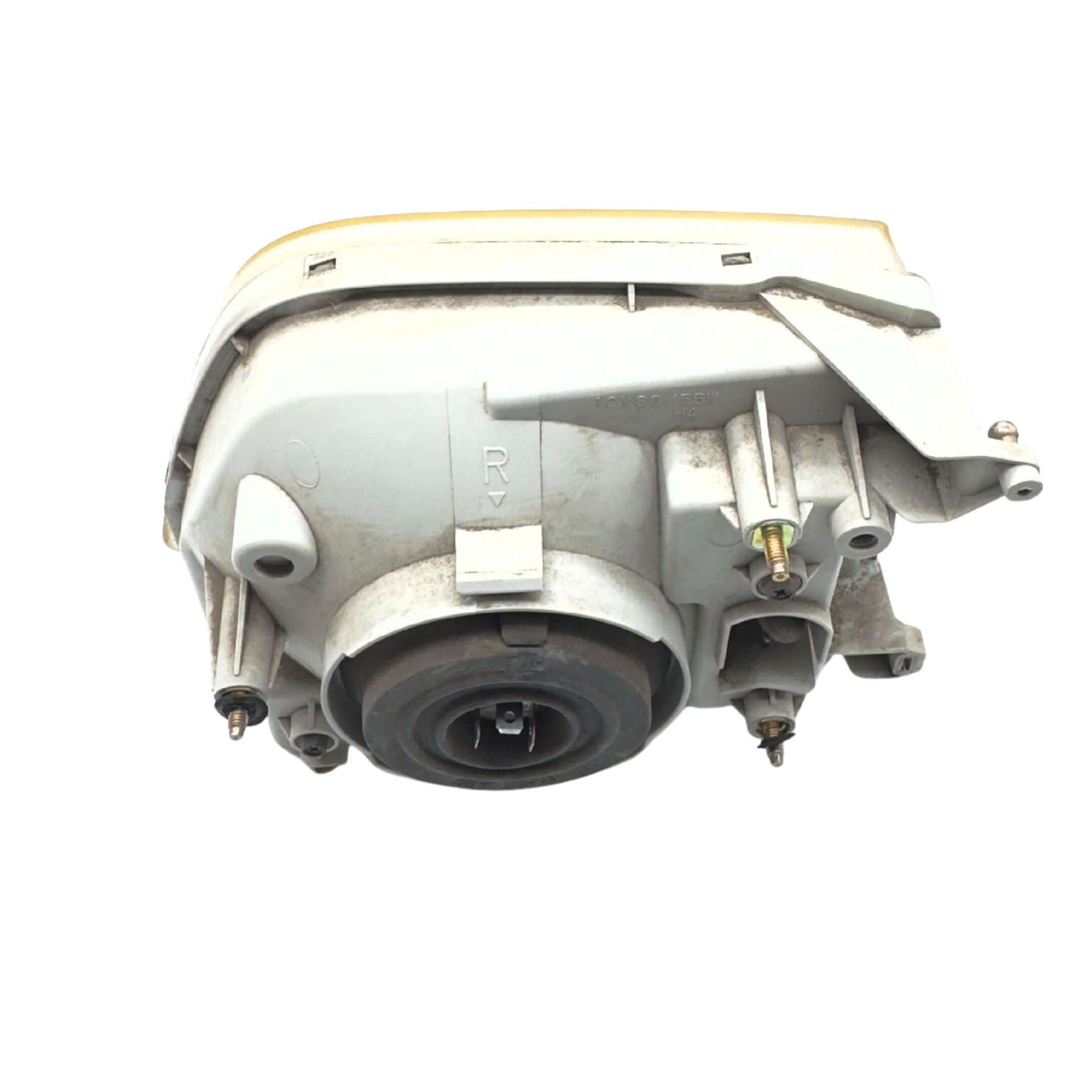Used left passenger side headlight for Subaru Sambar Truck TT1, TT2 models (2002-2012) featuring a durable housing and mounting points.