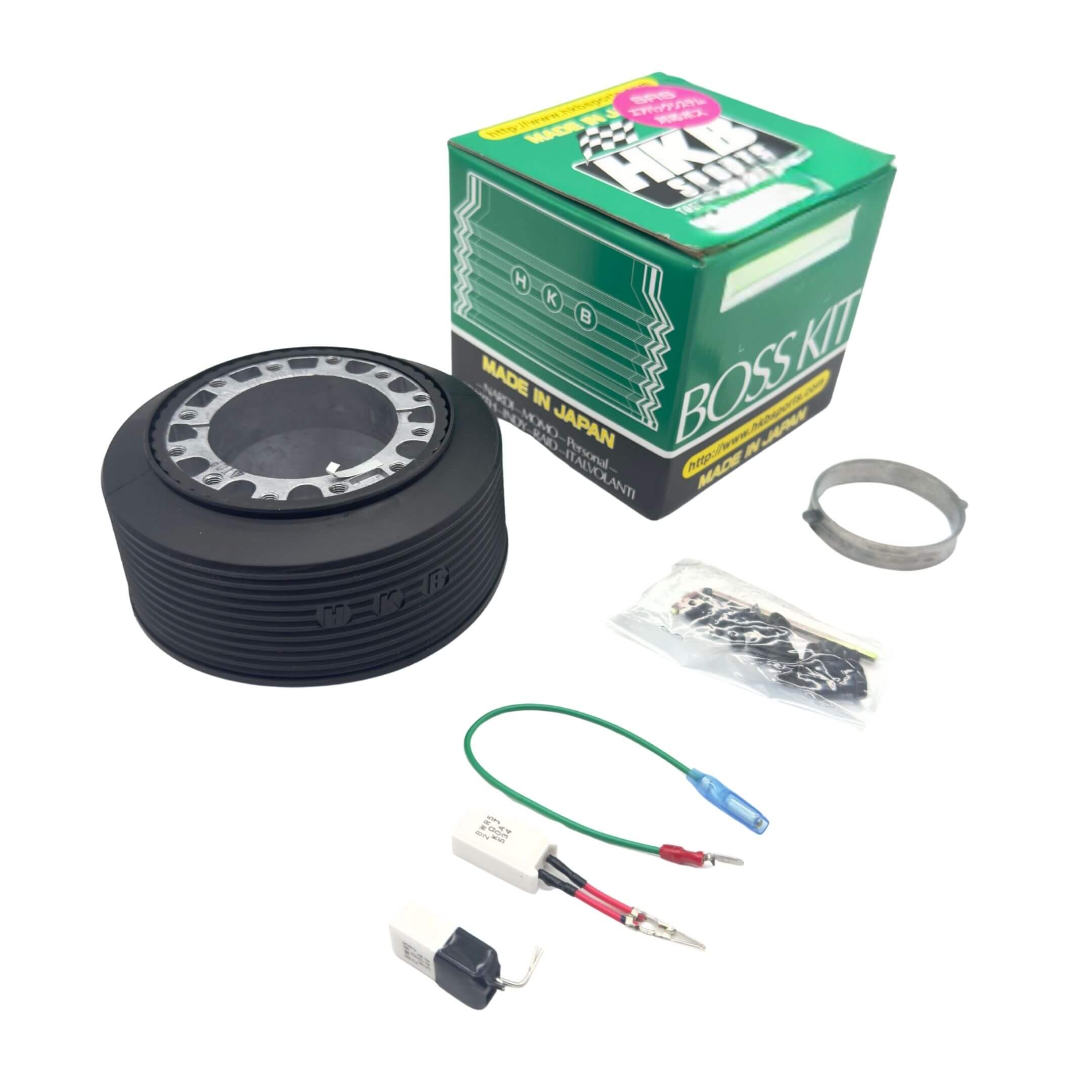 HKB Sports Boss Steering Wheel Hub Adapter for Subaru Sambar Van TV1, TV2 Models (1999-2012) featuring a black ribbed design and installation components.